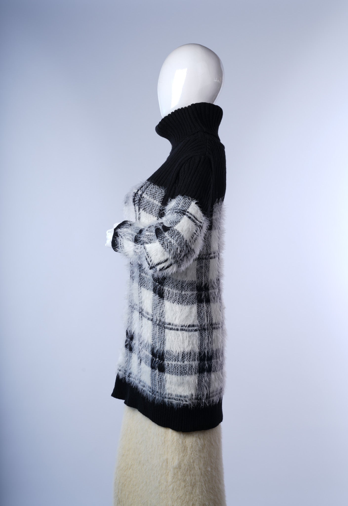 Chic black and white fuzzy knit dress featuring ribbed turtleneck and cuffs.