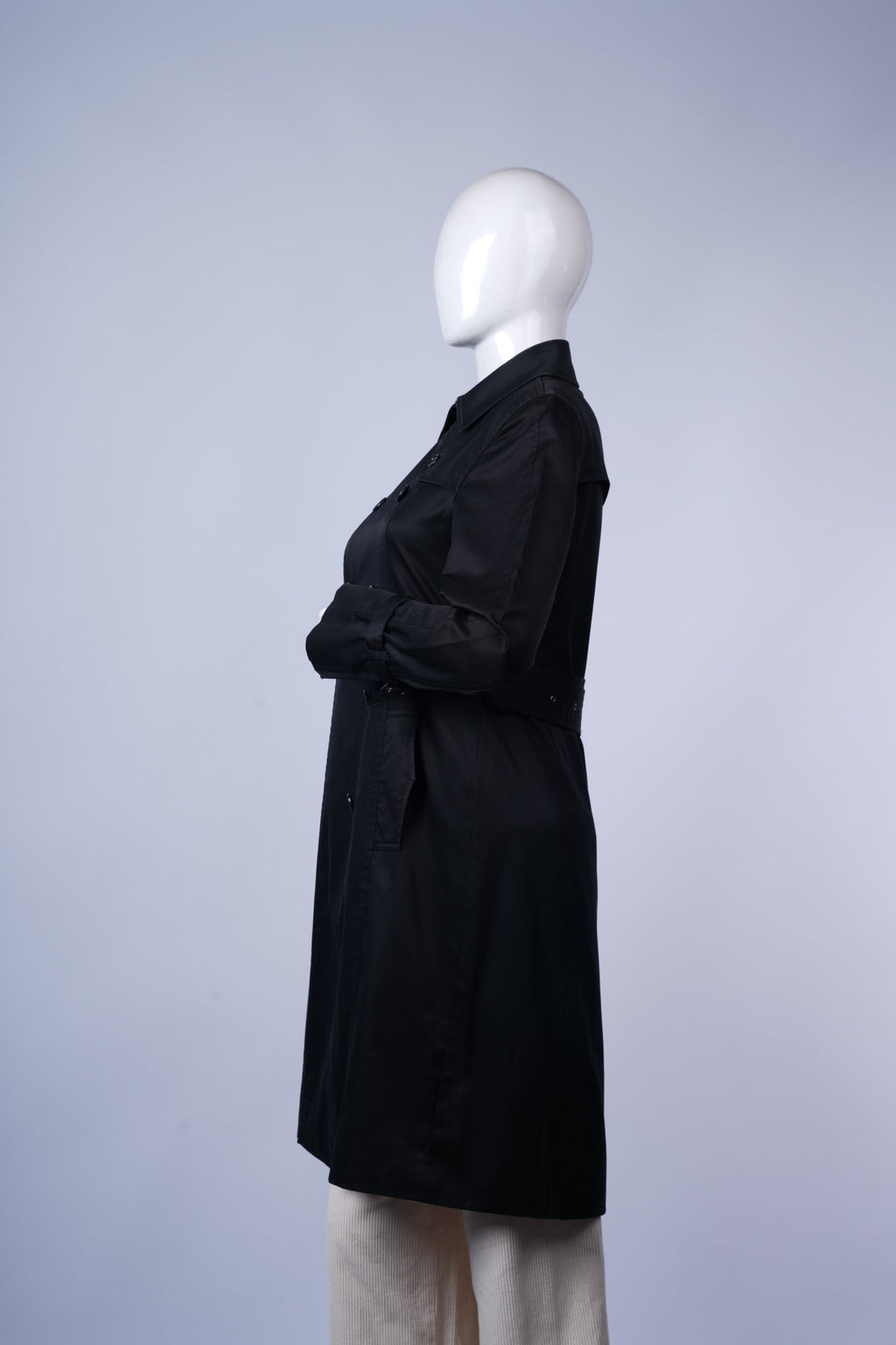Classic knee-length black trench coat with double-breasted front and versatile styling.