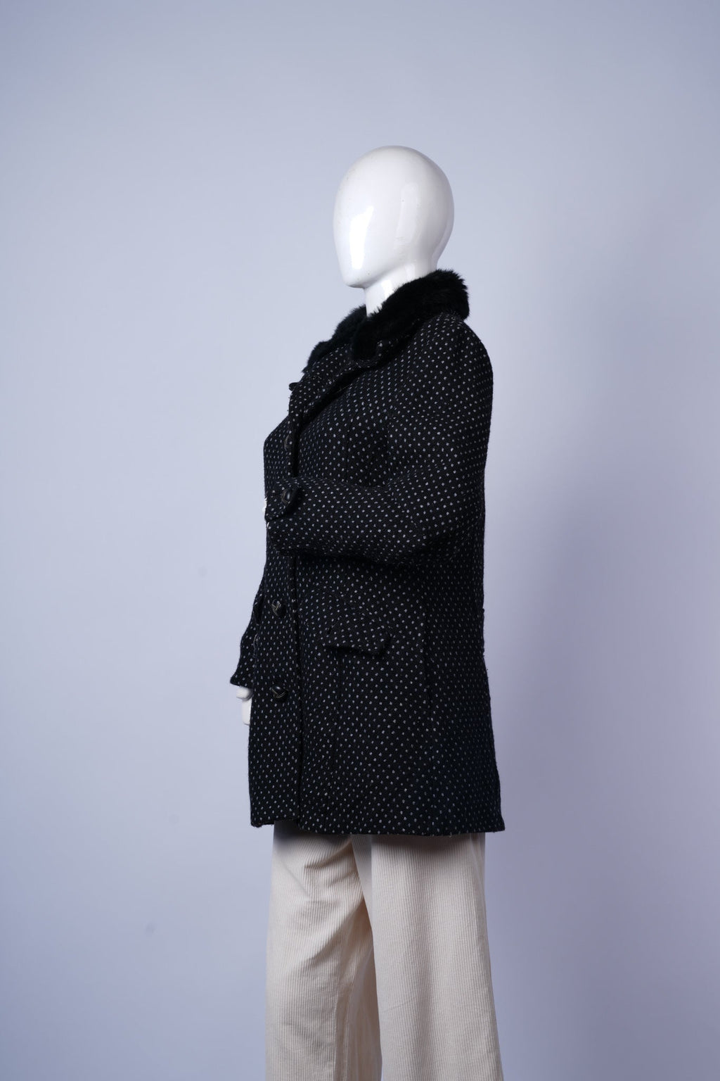 Rugged black coat with faux leather exterior, fur collar, and playful polka-dot interior.