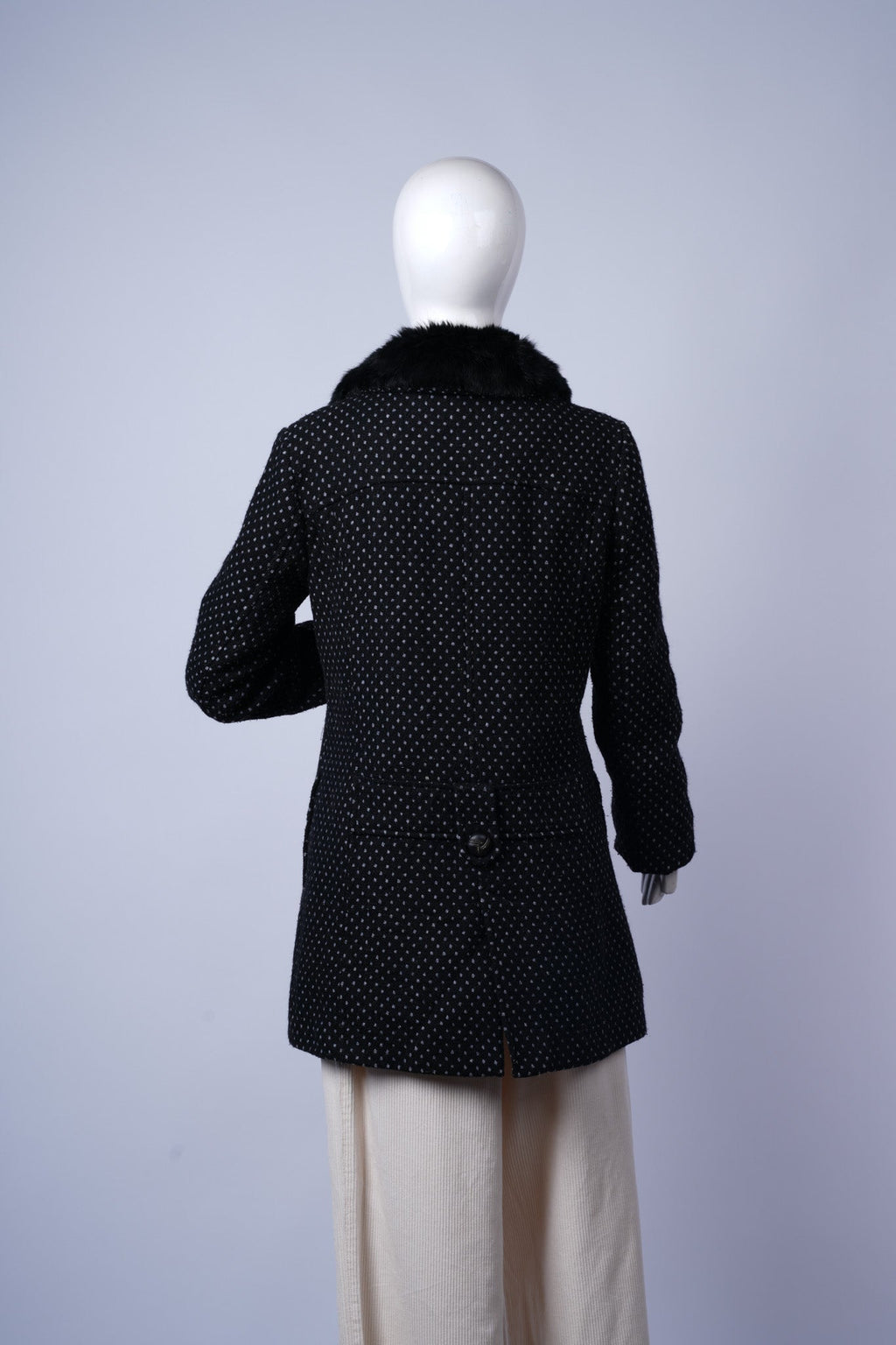 Vintage-chic black coat perfect for layering with bold lining and textured collar.