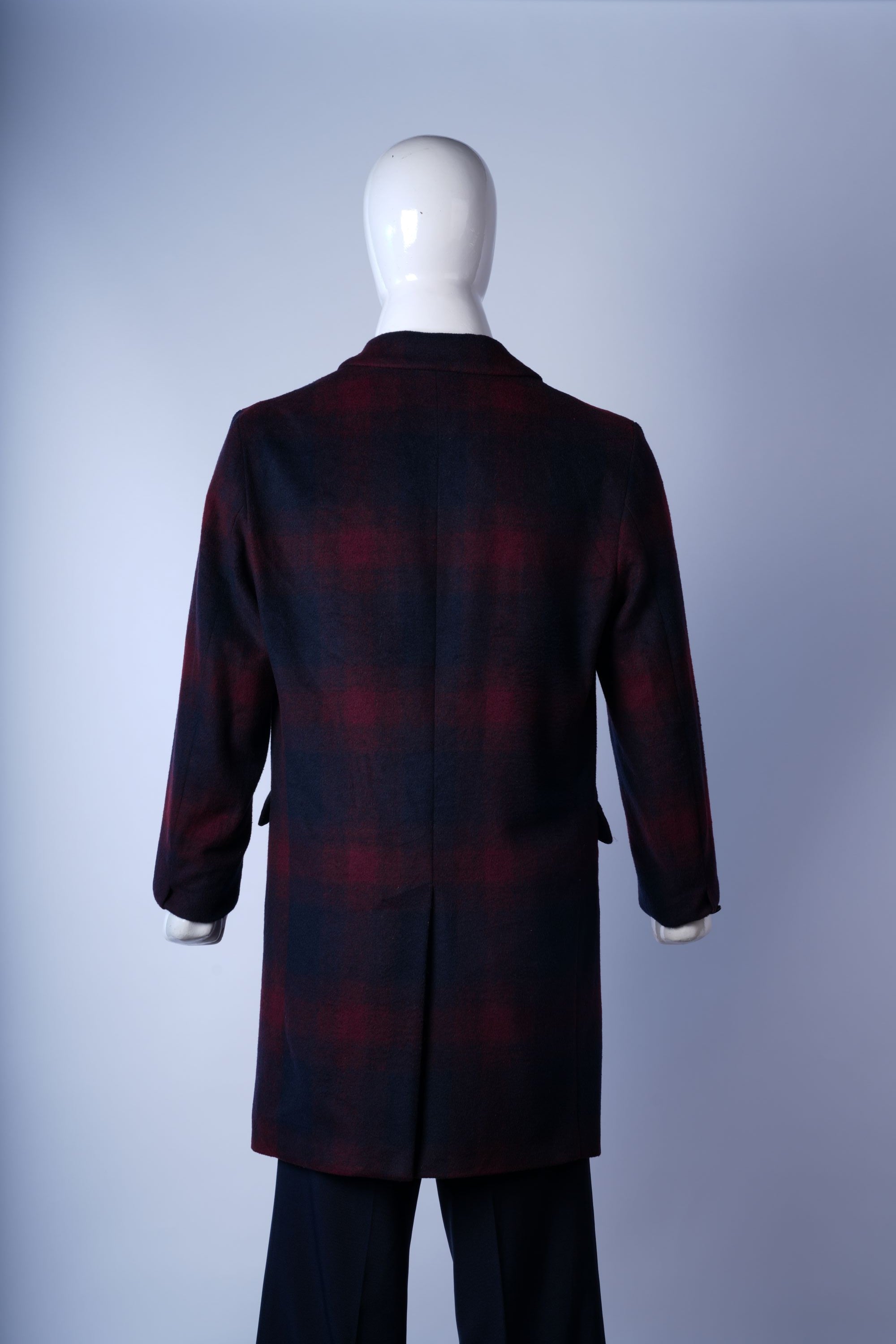 Stylish plaid overcoat with notched lapels, perfect for casual or formal layering.