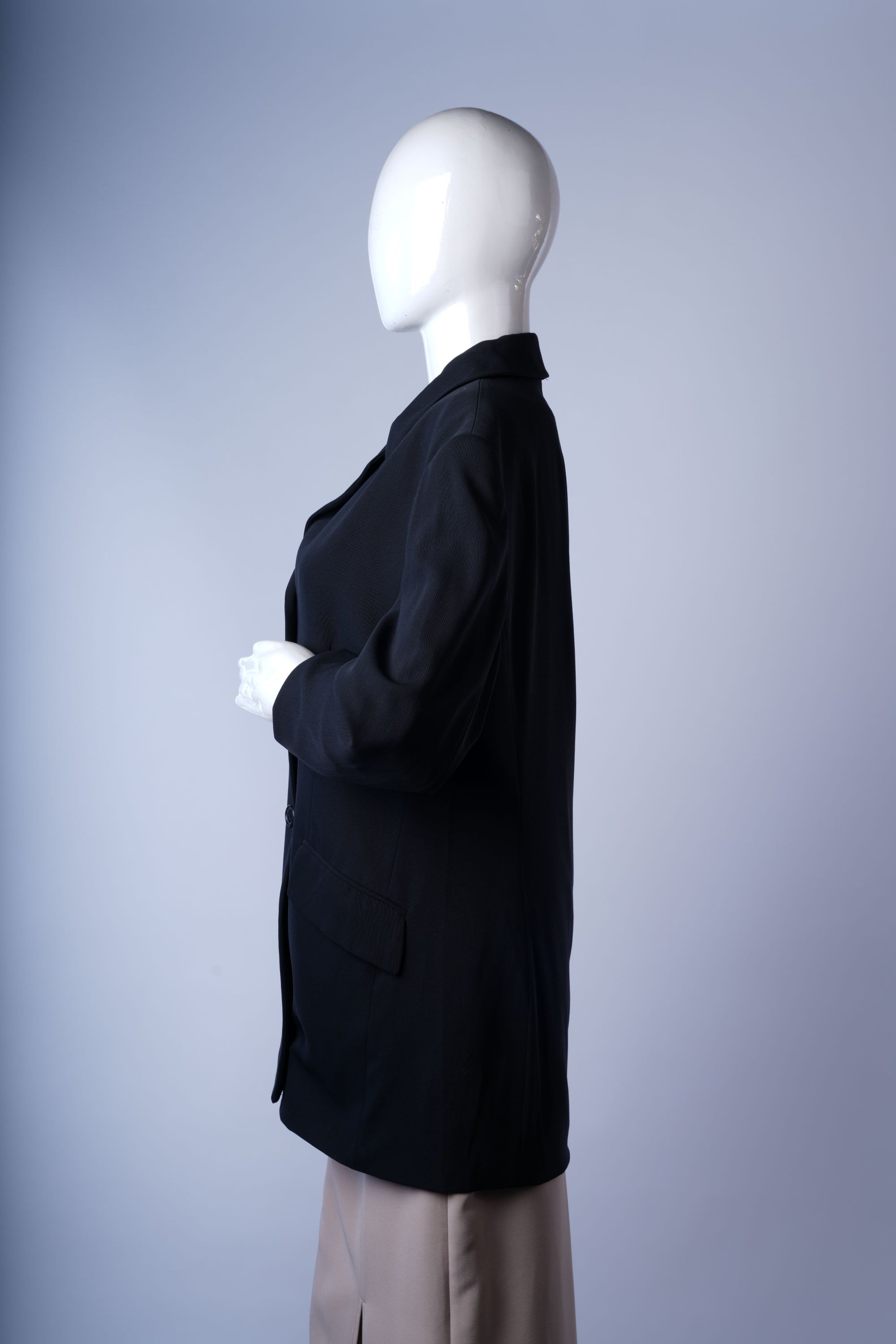 Elegant black coat featuring tailored fit, flap pockets, and traditional lapels.