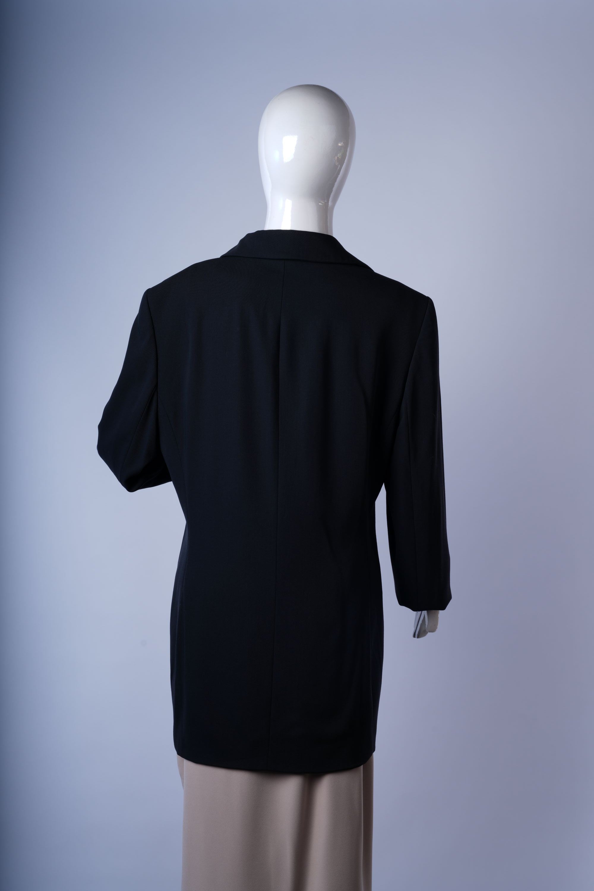 Classic black three-button coat perfect for professional or business outfits.
