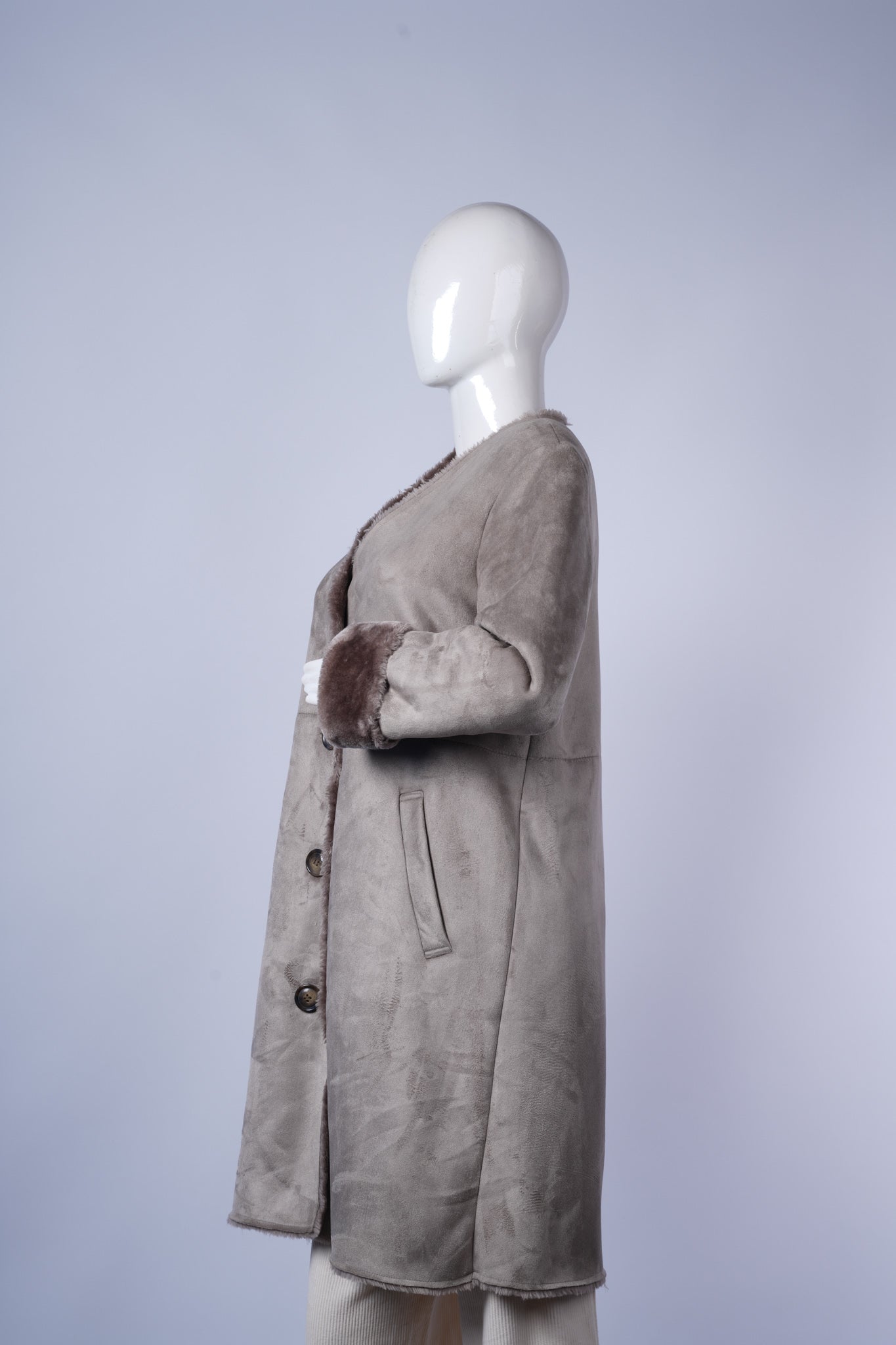 Casual beige jacket with button closure and functional patch pockets for everyday wear.