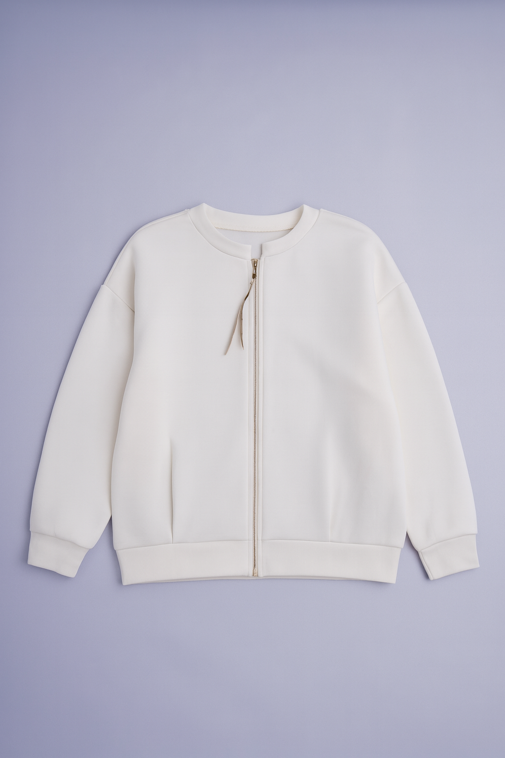 White jacket with ribbed cuffs, hem, and gold-toned vertical back zipper.