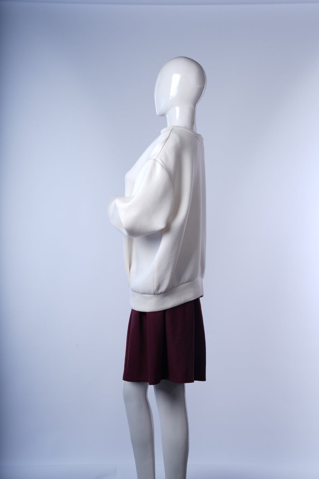 Stylish white jacket featuring ribbed trims and standout back zipper detail.