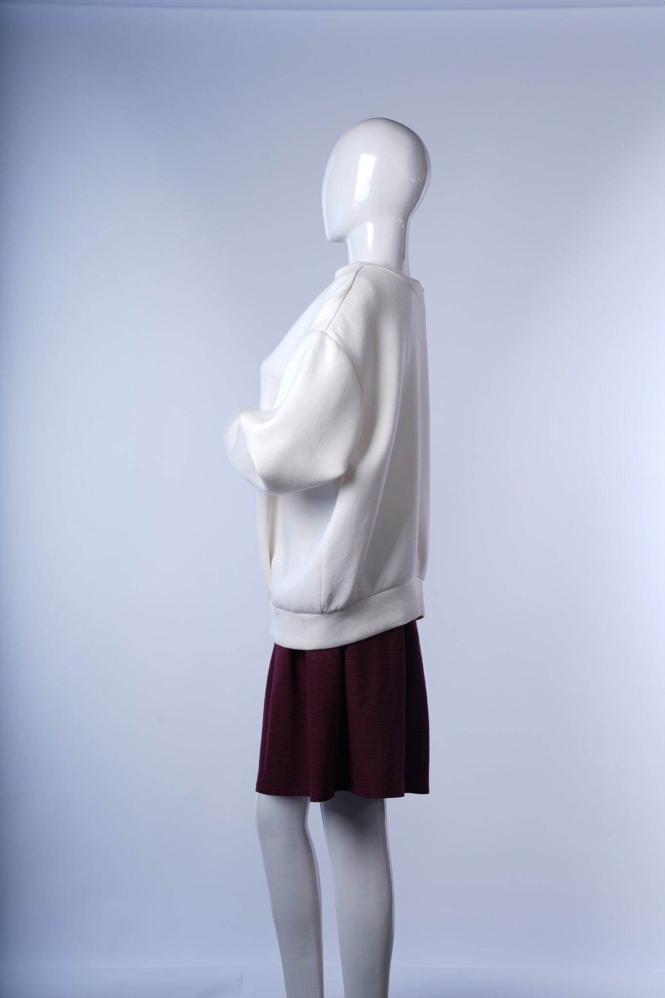 Stylish white jacket featuring ribbed trims and standout back zipper detail.