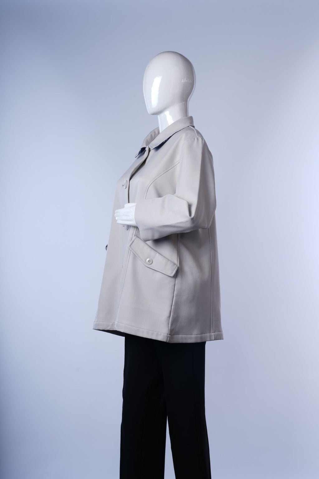 Elegant long coat with classic lapels, button-front closure, and practical pockets.