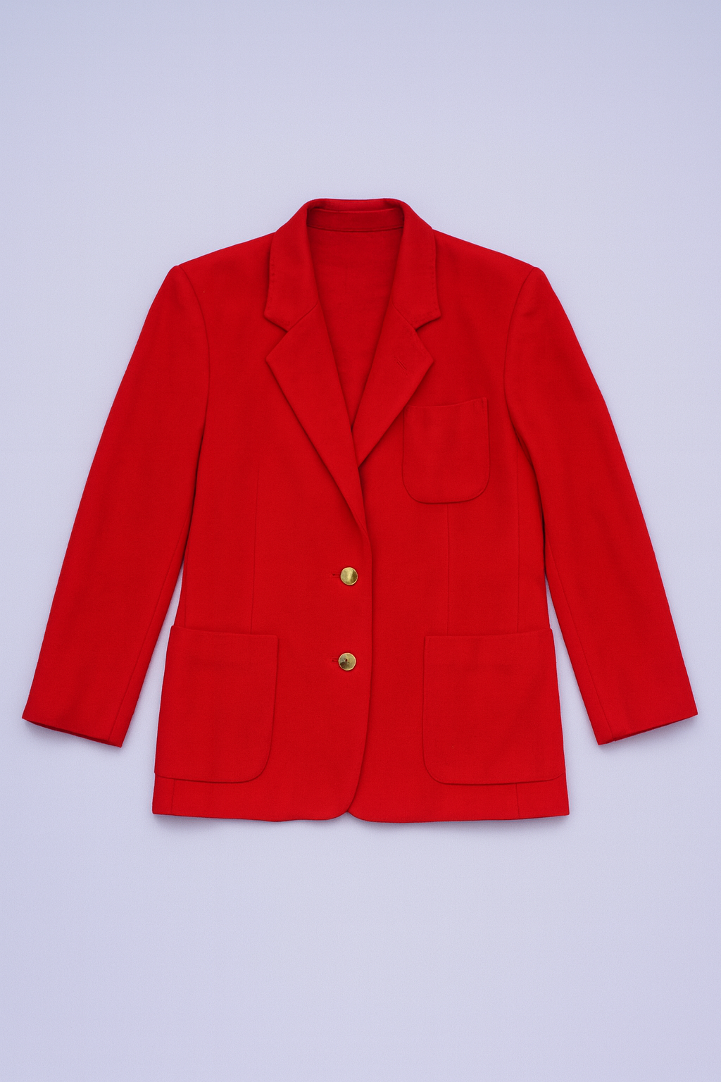 Red wool-blend blazer with notched lapels, two-button closure, flap waist pockets, and chest welt pocket.