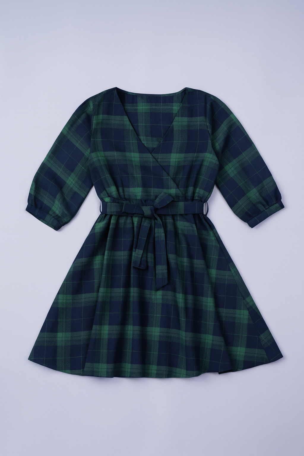 Green and blue plaid A-line dress with square neckline and matching waist belt.