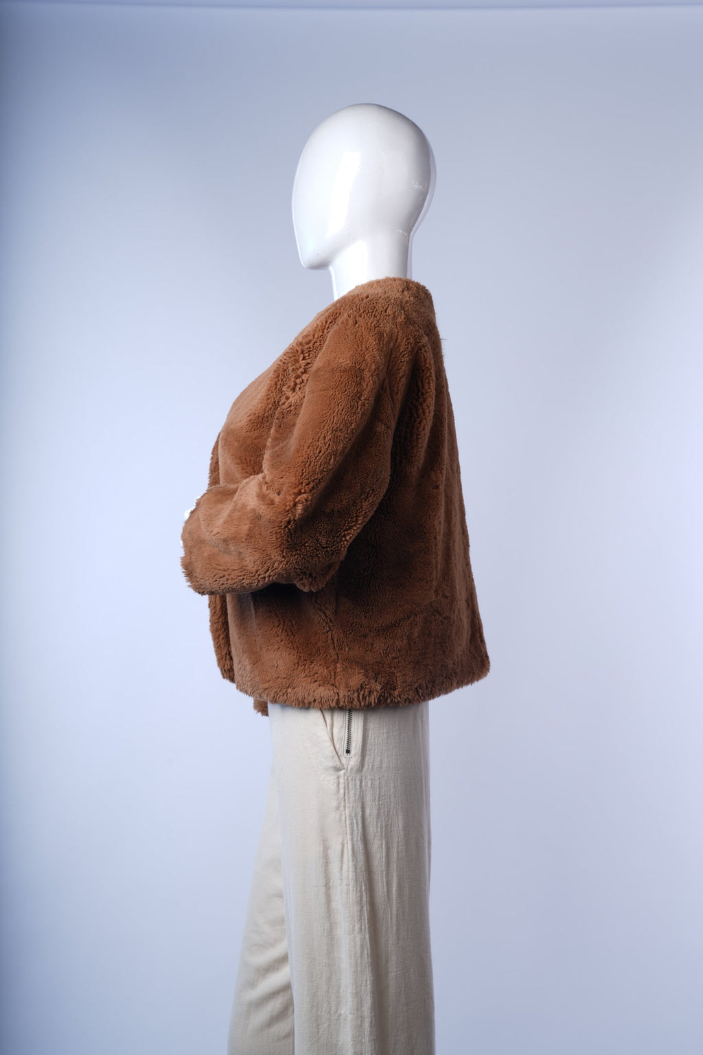 Cozy women's winter jacket in camel with soft, plush faux fur texture.