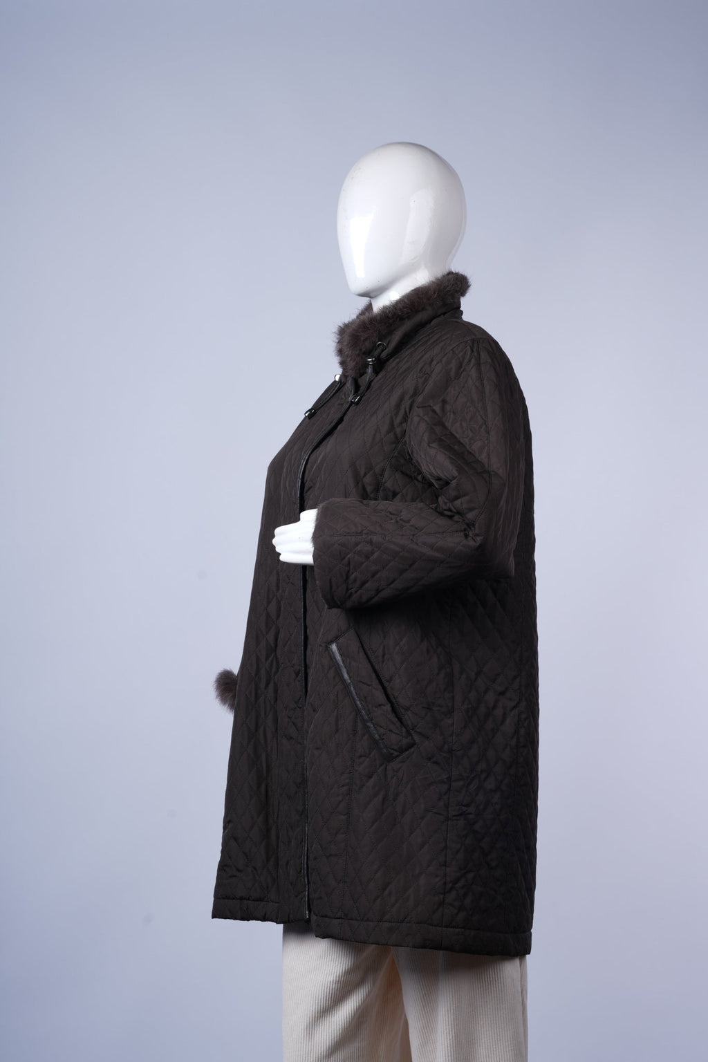 Dark winter jacket featuring cozy fur collar and practical zip closure.