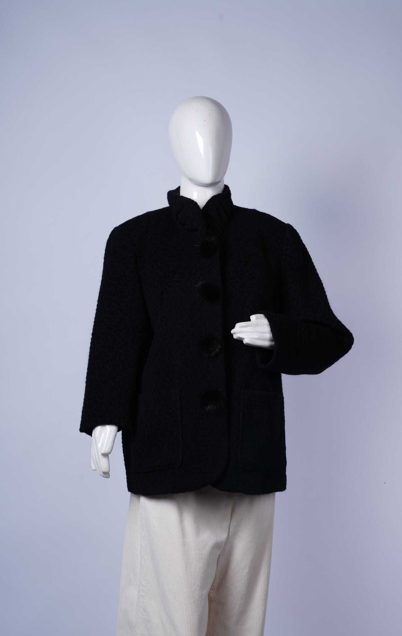 women's formal black coat featuring richly woven fabric and refined design.