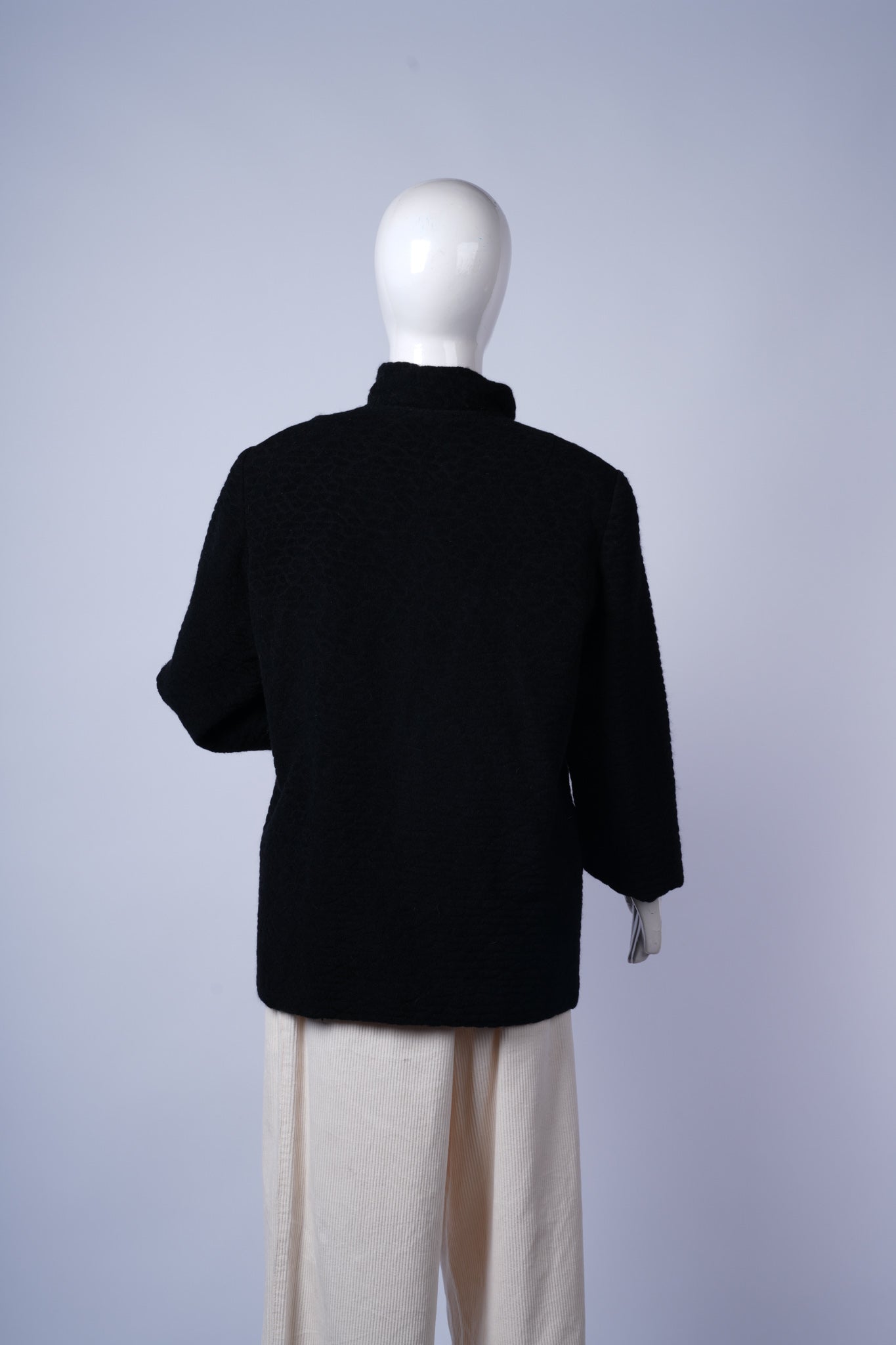 Sophisticated high-collar black coat perfect for polished formal outfits.