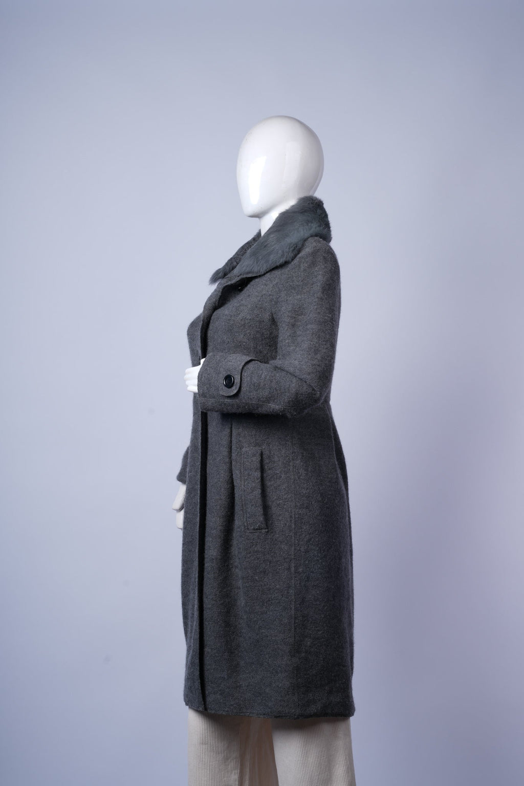 Timeless grey wool coat featuring detachable fur trim and classic tailored design.
