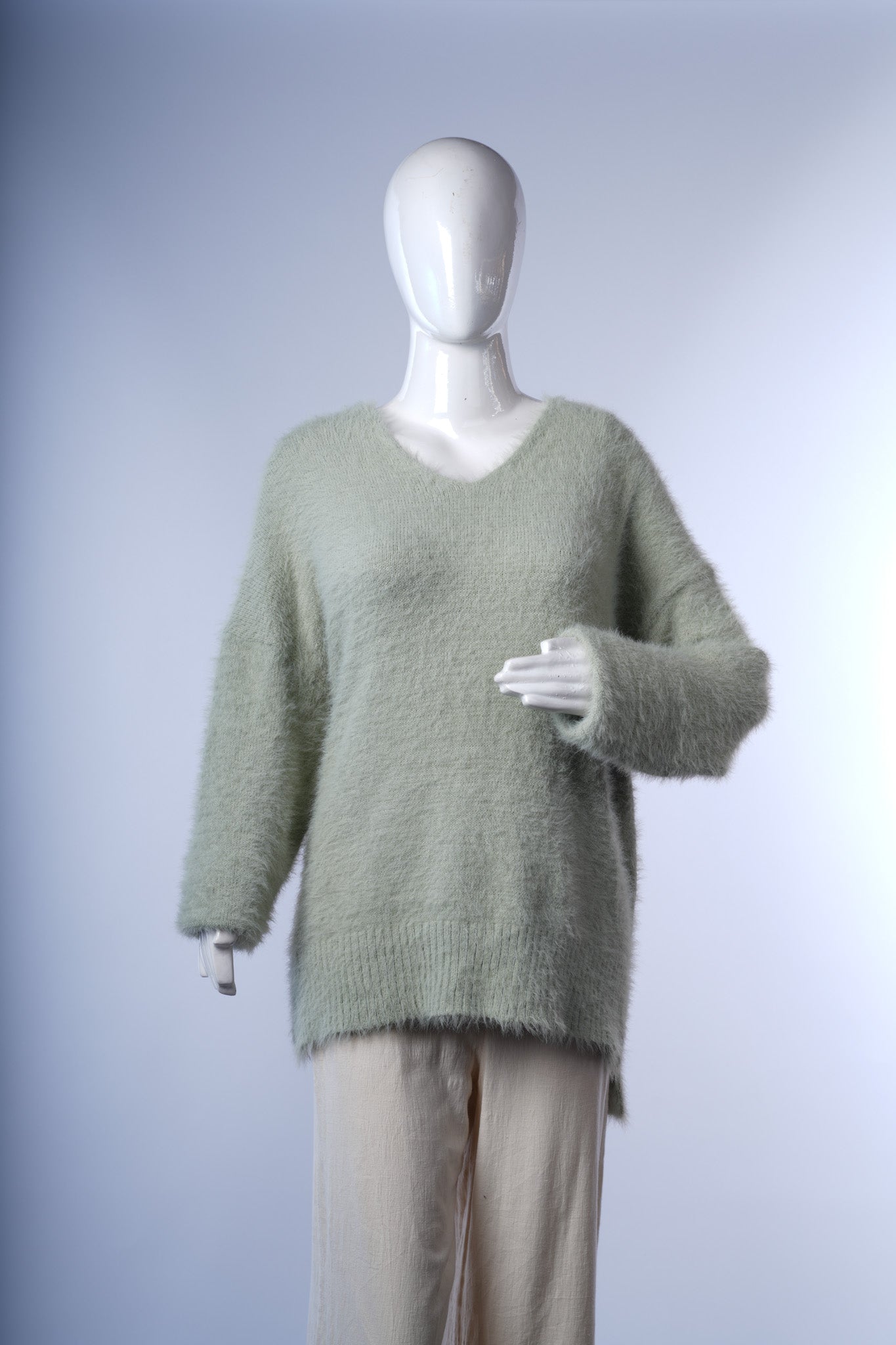 Cozy V-neck fuzzy sweater for women, ideal for casual layering.