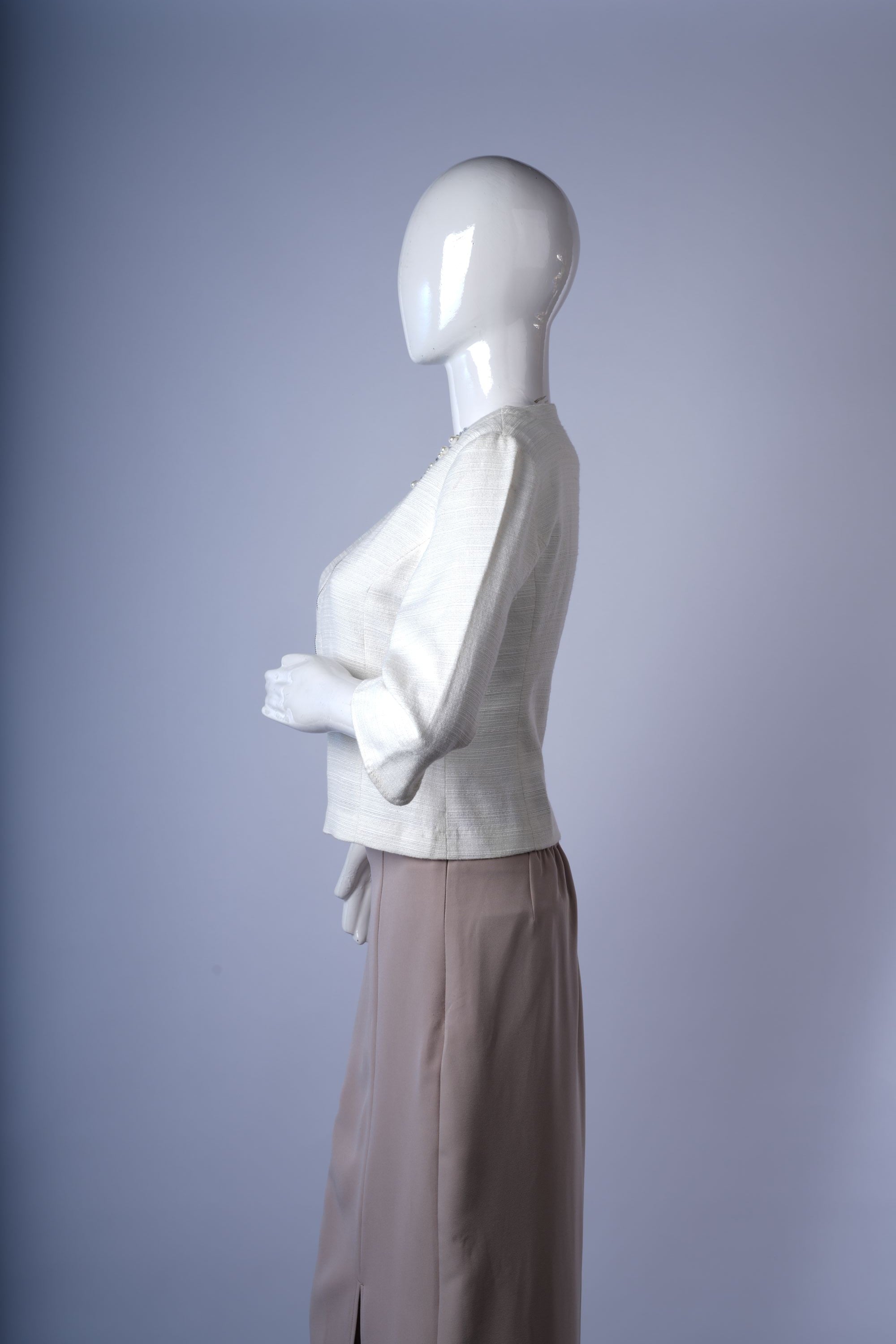 Stylish collarless jacket with decorative beading and sequins for polished outfits.