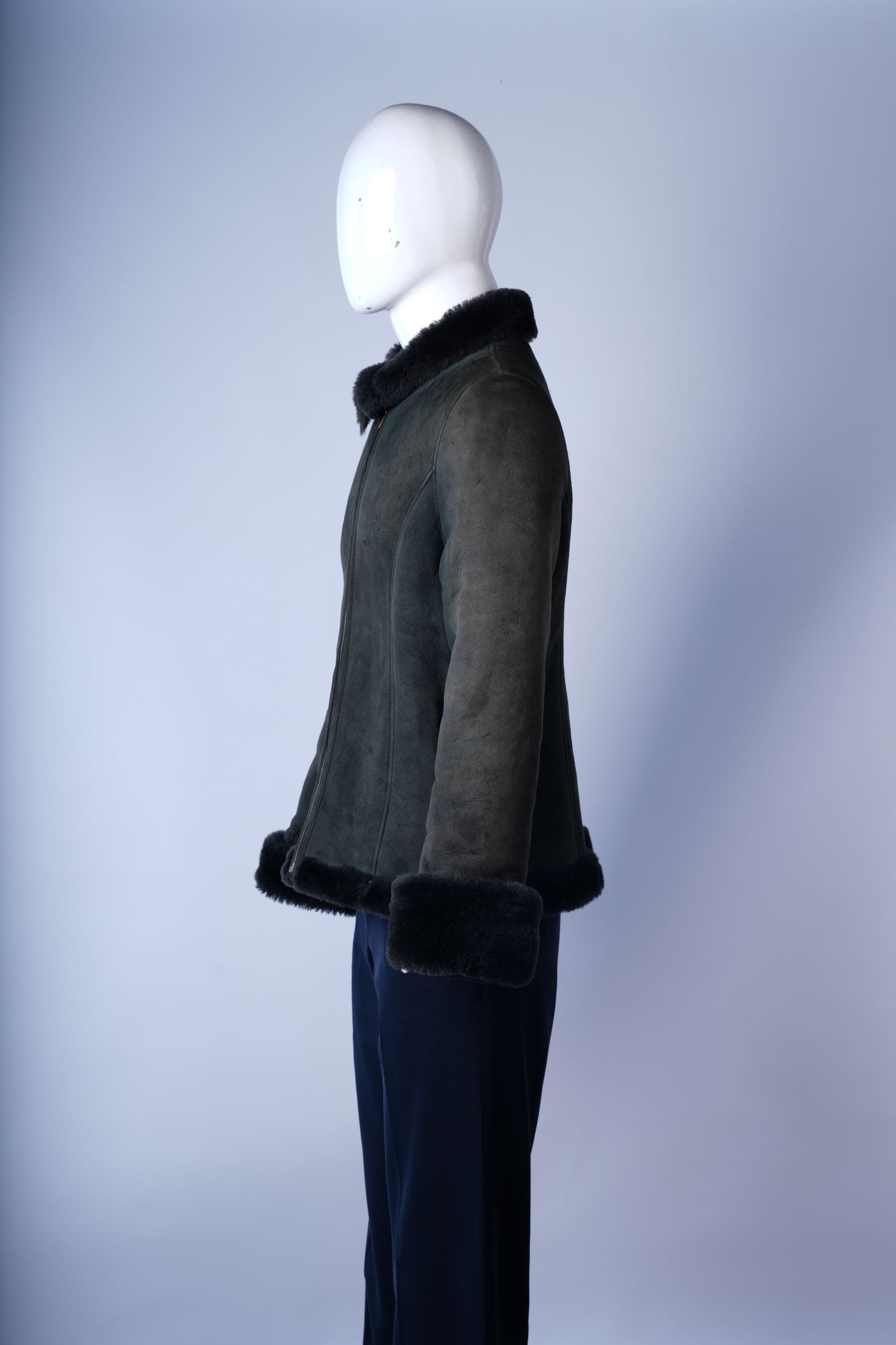 Cozy dark green bomber jacket with soft fur interior and stylish suede exterior.
