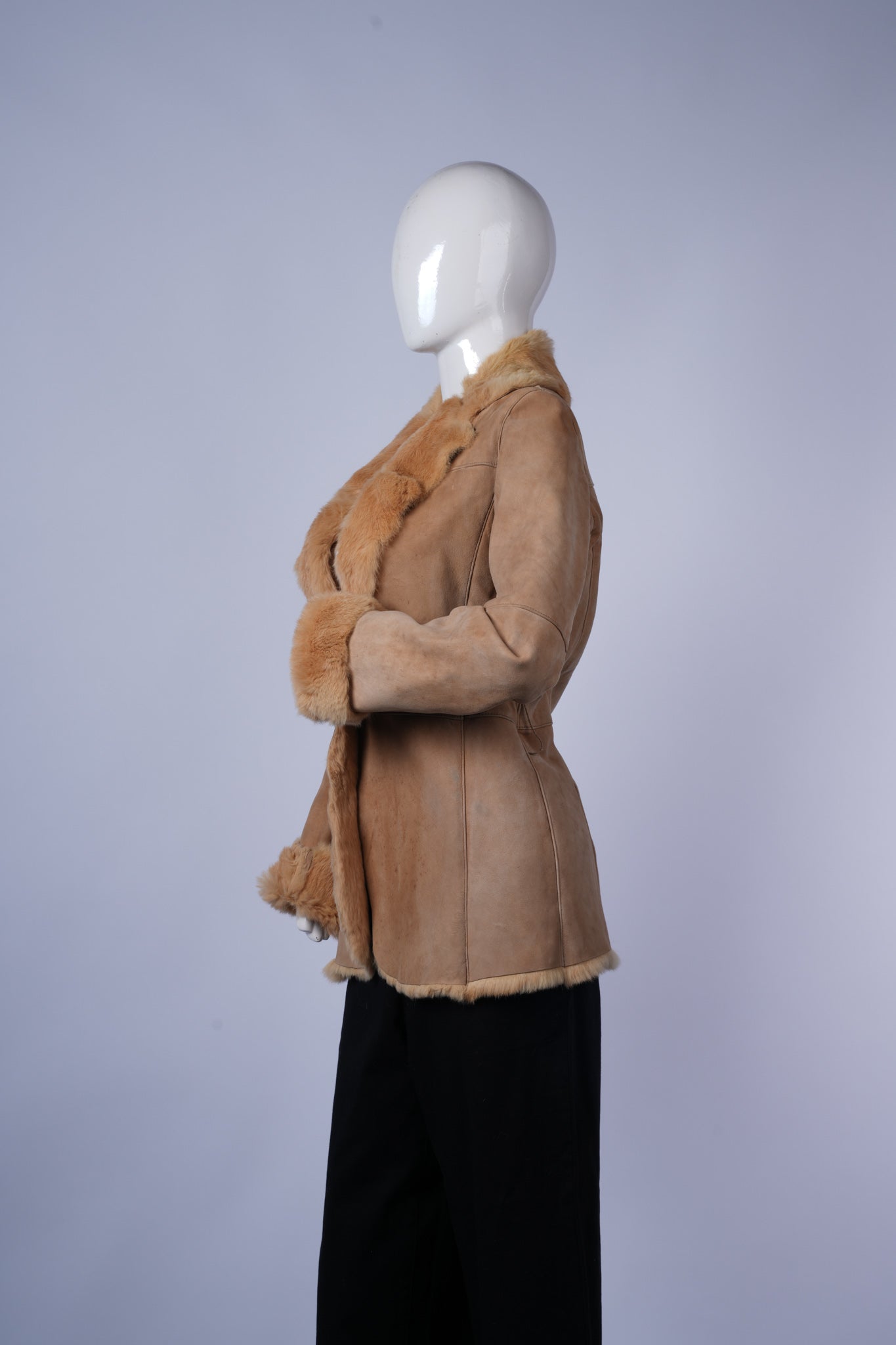 Warm tan jacket with luxurious shearling interior and stylish collar detail.