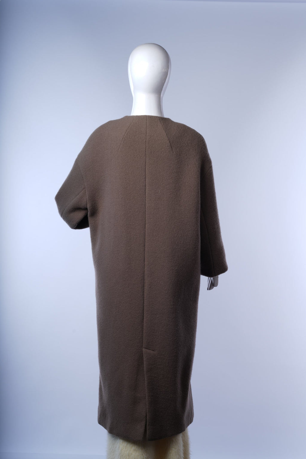 Modern collarless wool coat for women, perfect for vintage-inspired layering.