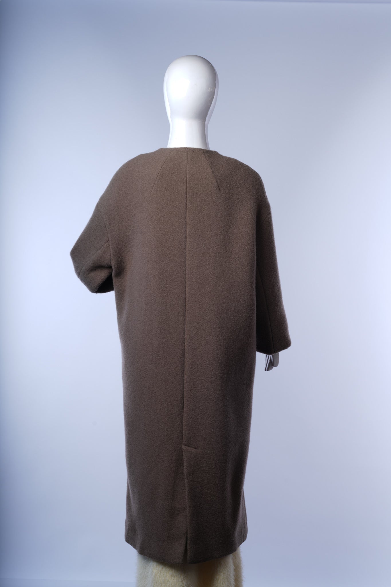 Modern collarless wool coat for women, perfect for vintage-inspired layering.