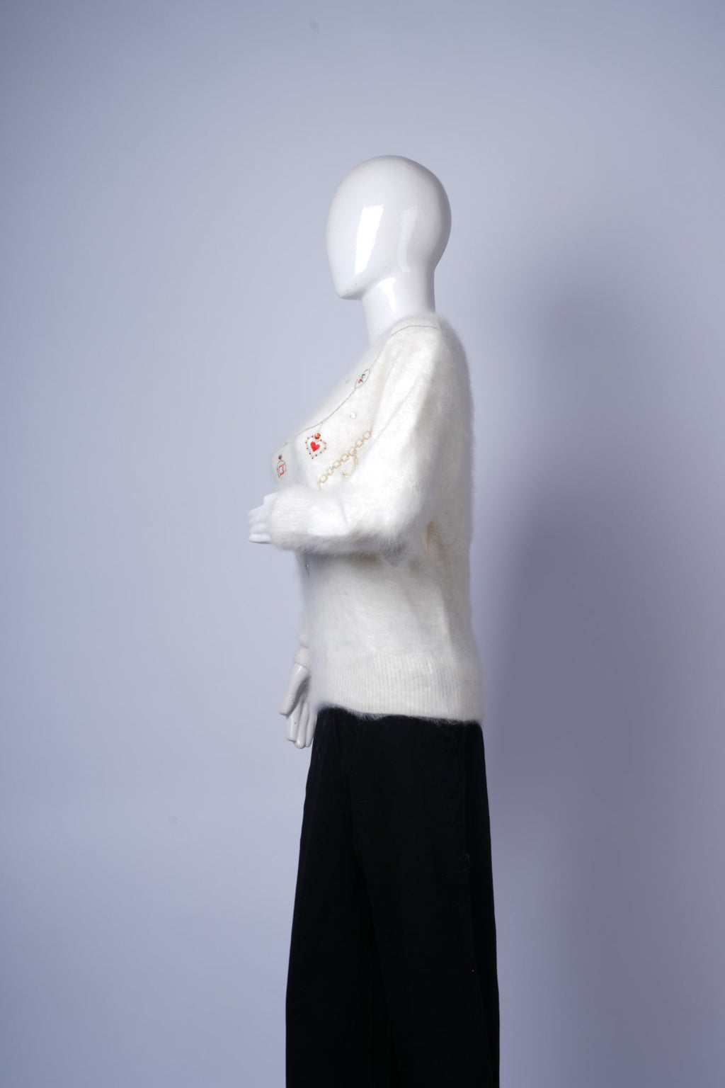 Elegant knit sweater in cream with standout embellishments for casual or semi-formal wear.