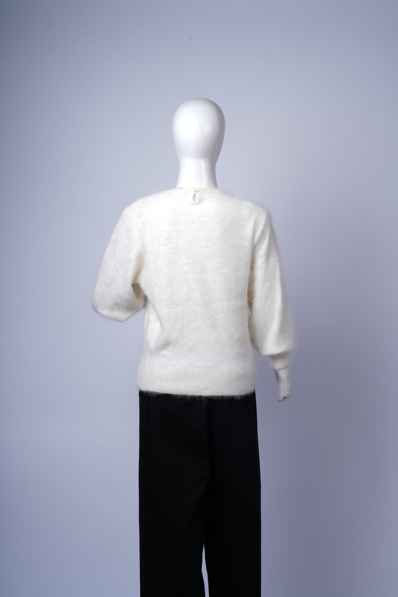 Chic cream sweater featuring intricate gold and pearl details for polished outfits.