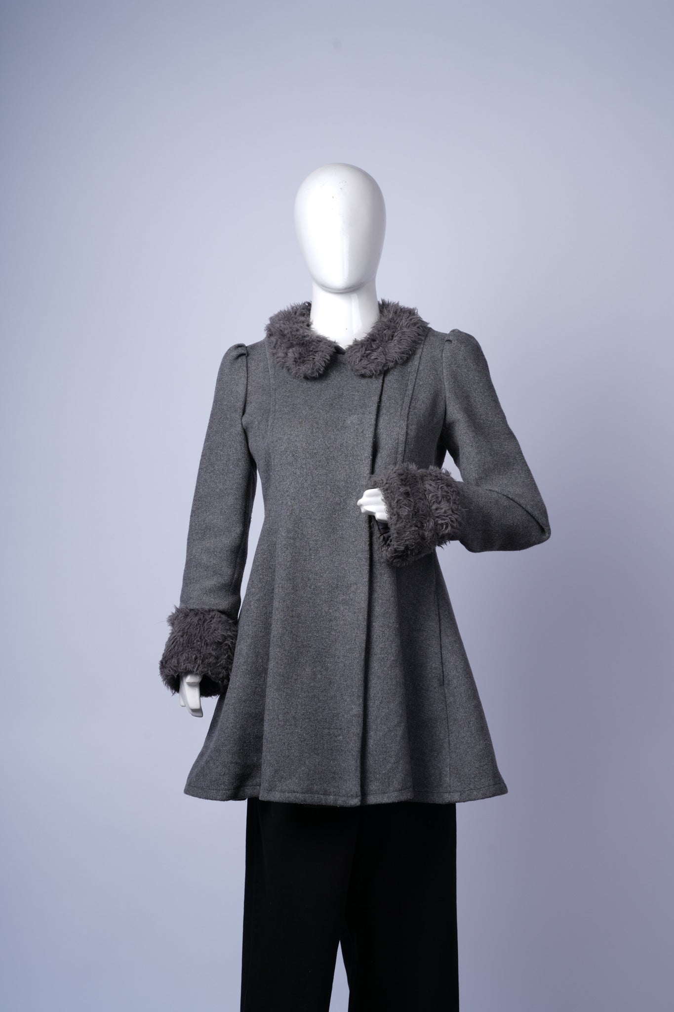 women's stylish coat featuring asymmetrical buttons and cozy fur collar and cuffs.