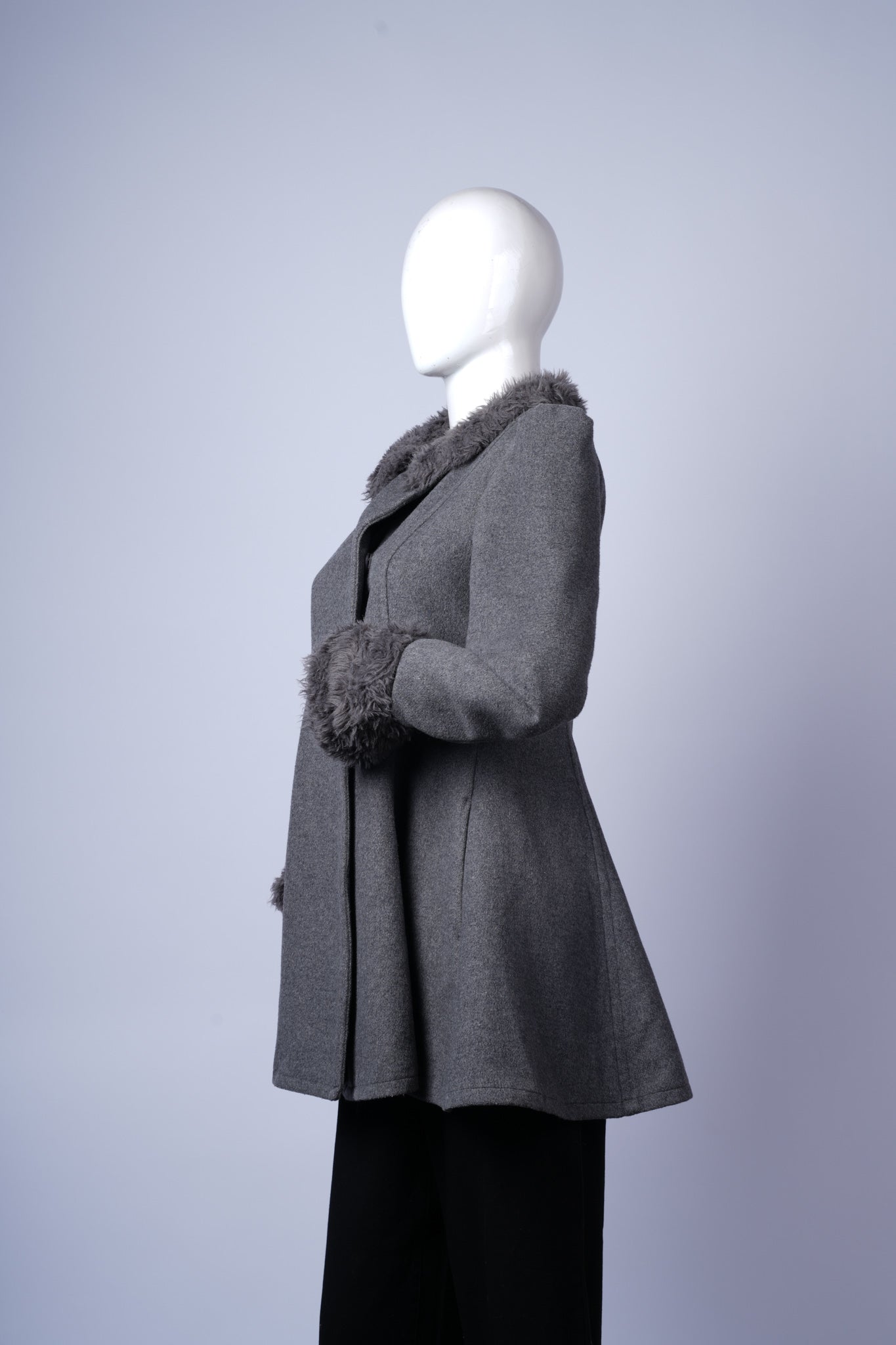 Chic grey coat with structured silhouette, perfect for layered cold-weather outfits.