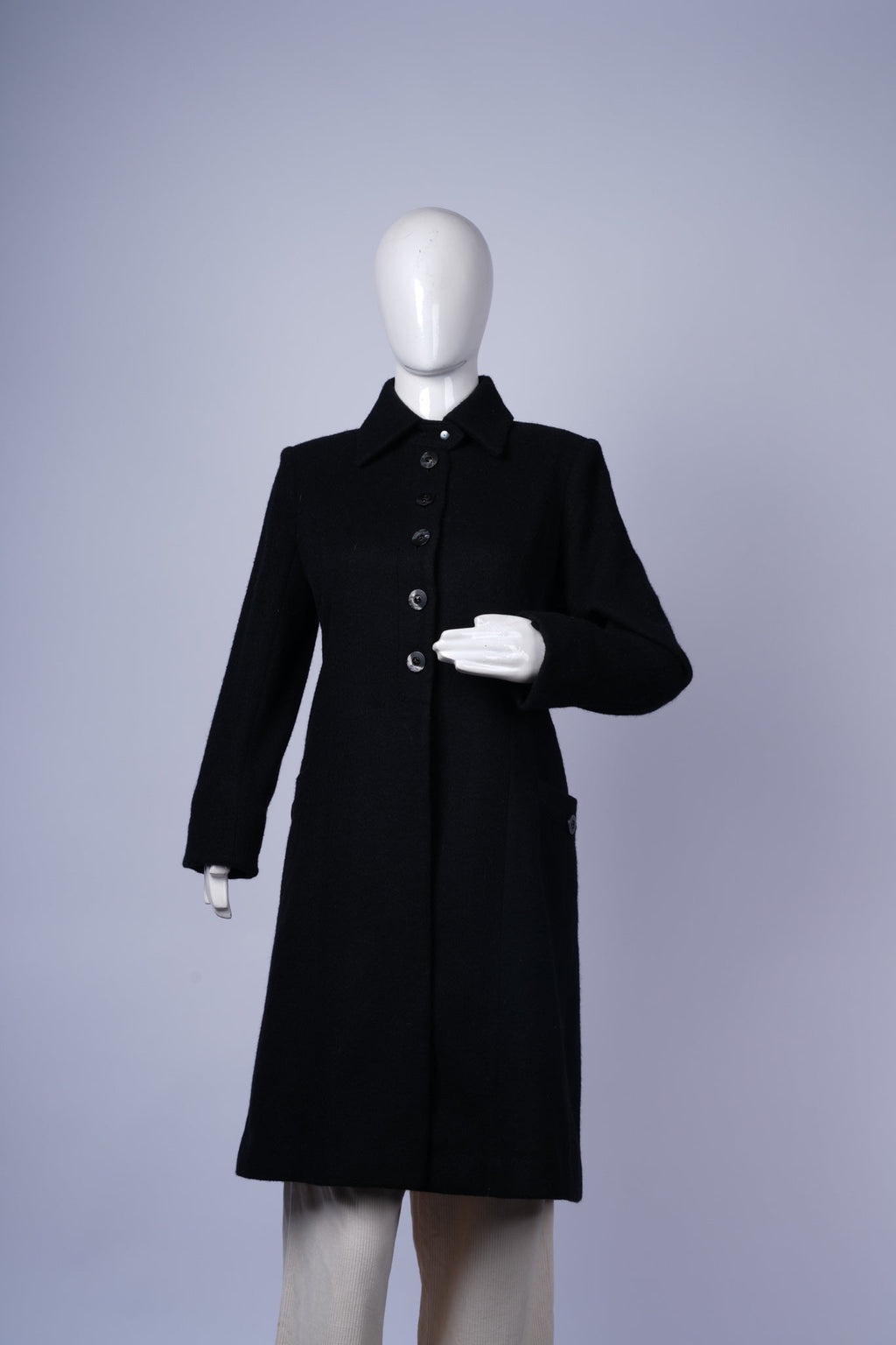 women's classic black coat featuring button-up front and modern contrasting interior.