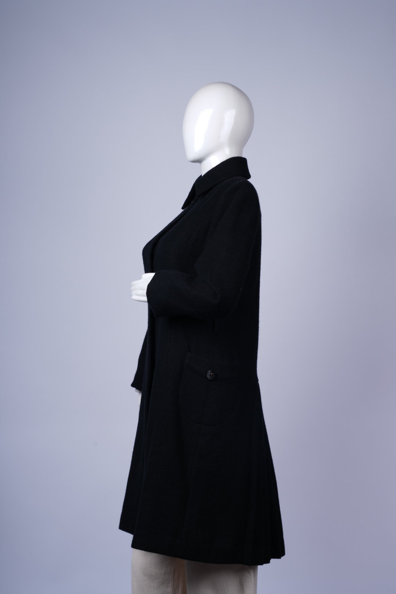 Elegant wool-blend coat with sleek fit and striking detail.