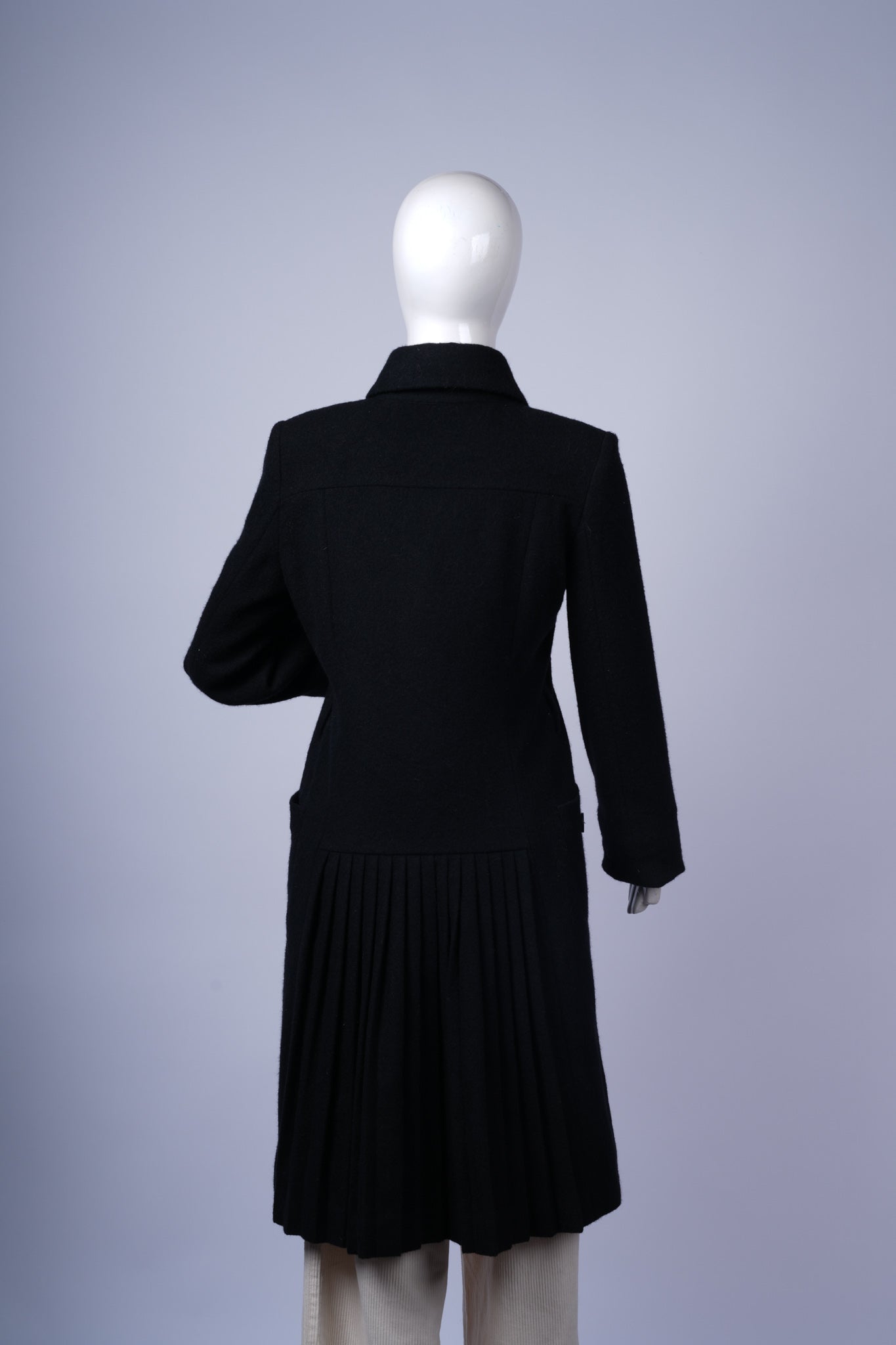Stylish mid-length black coat perfect for professional or casual winter wear.