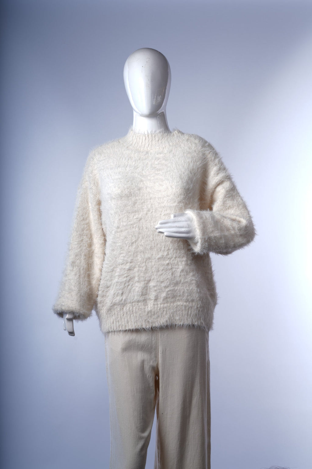 Cozy white faux fur sweater for women, ideal for layering over casual or formal outfits.