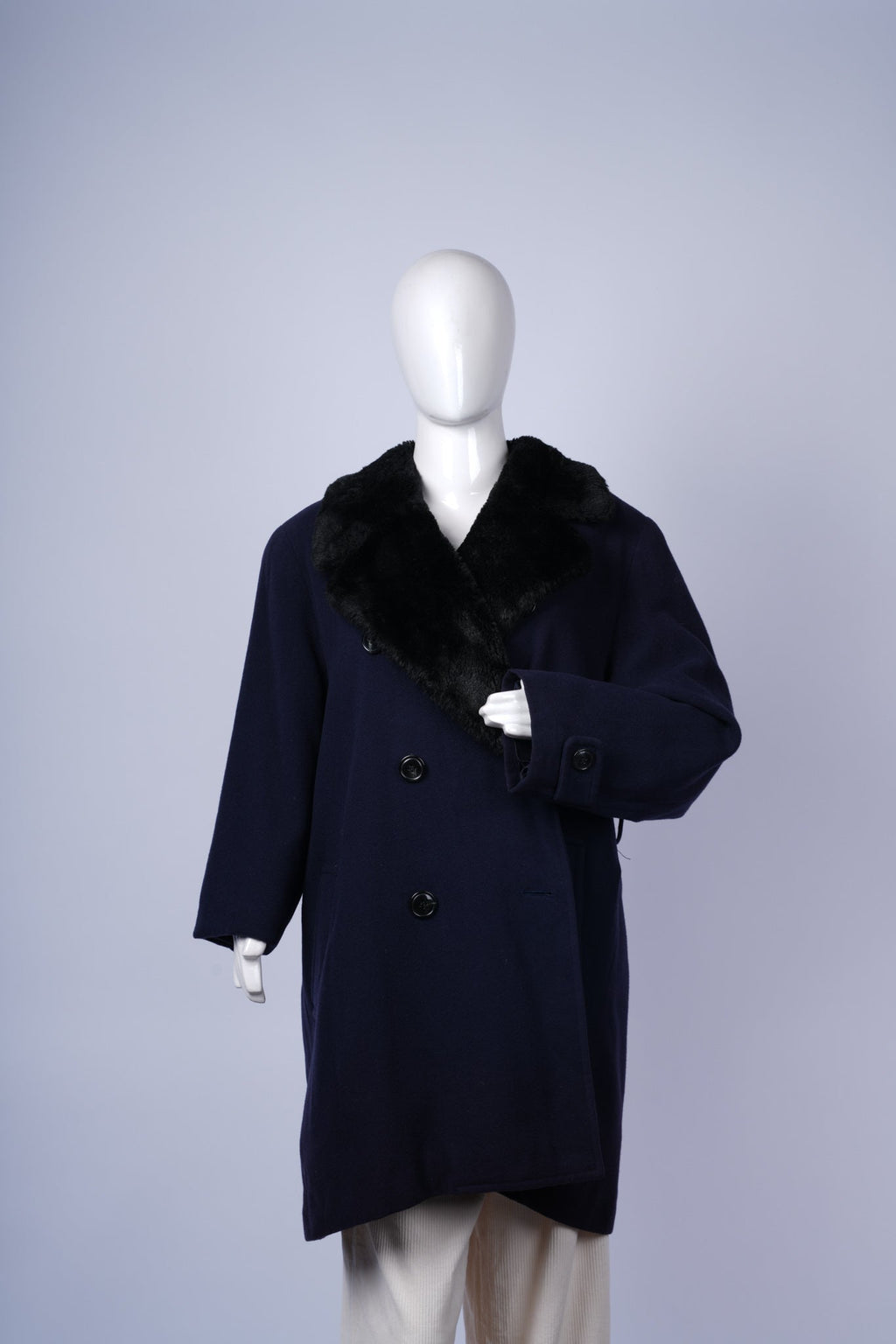 Elegant navy wool coat featuring double-breasted design and plush black fur collar.
