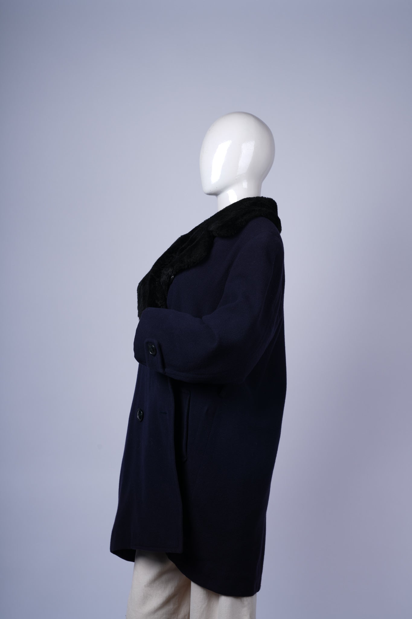 Versatile women's coat in navy with luxurious black fur-trimmed collar.