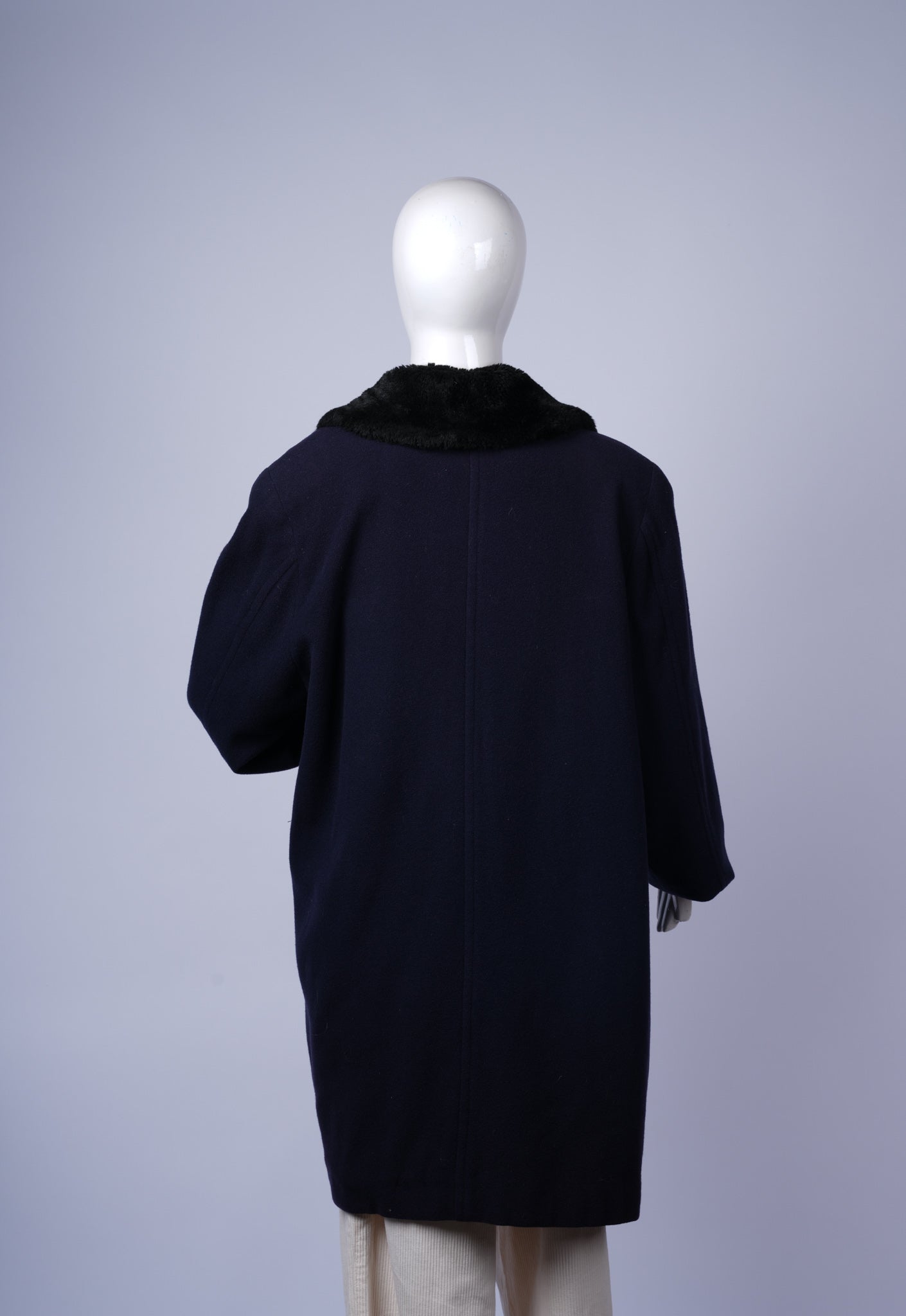 Stylish double-breasted navy wool coat, ideal for formal or casual winter wear.