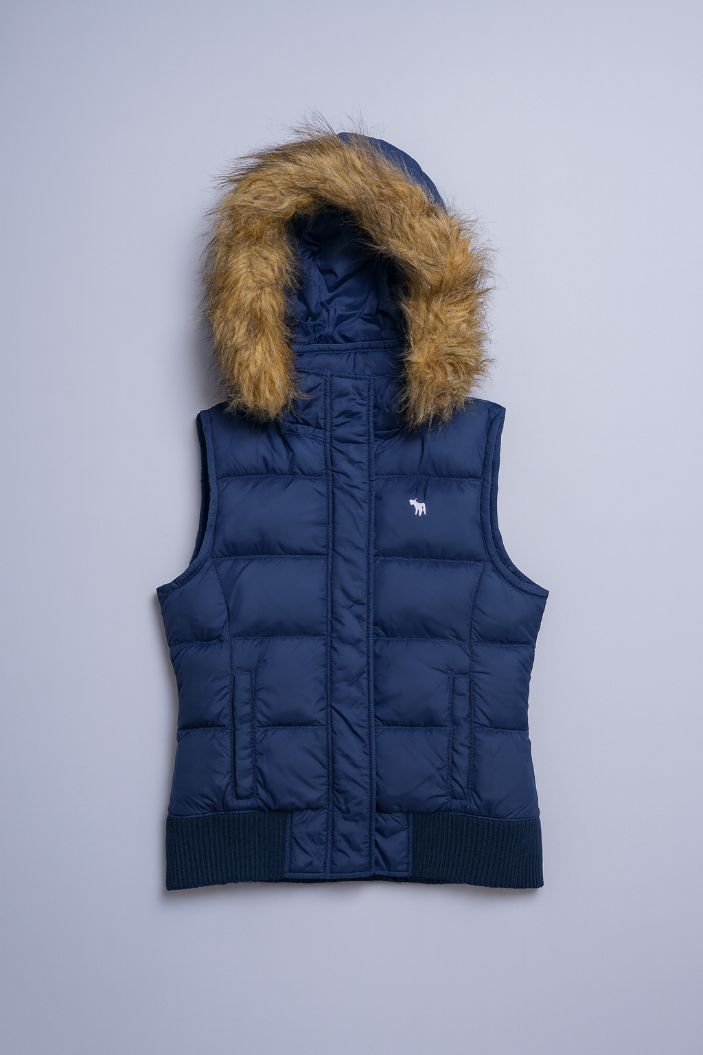 Quilted navy puffer vest with detachable faux-fur jacket and full-zip front.