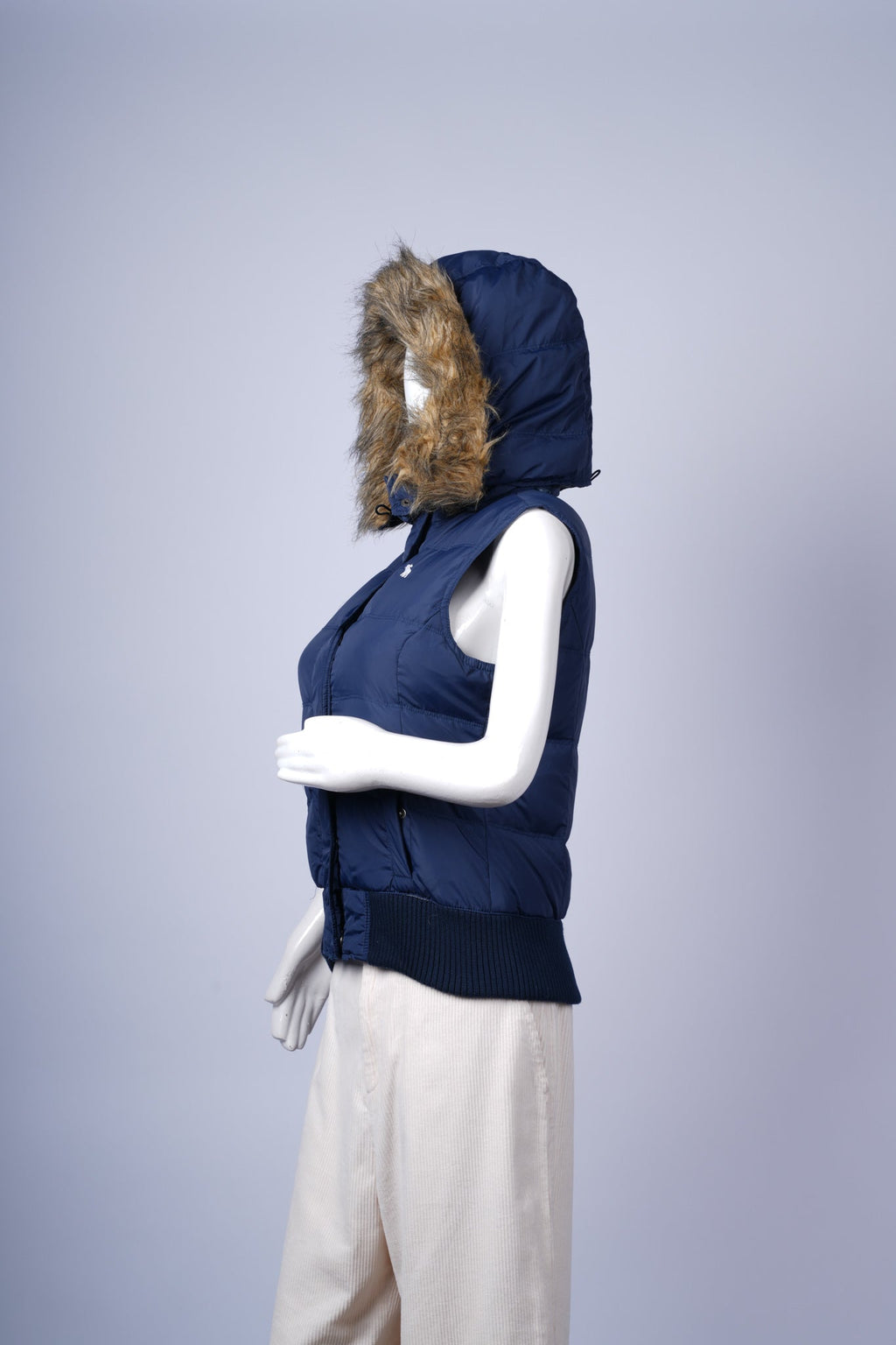 Warm quilted vest featuring detachable faux-fur jacket and practical zip closure.