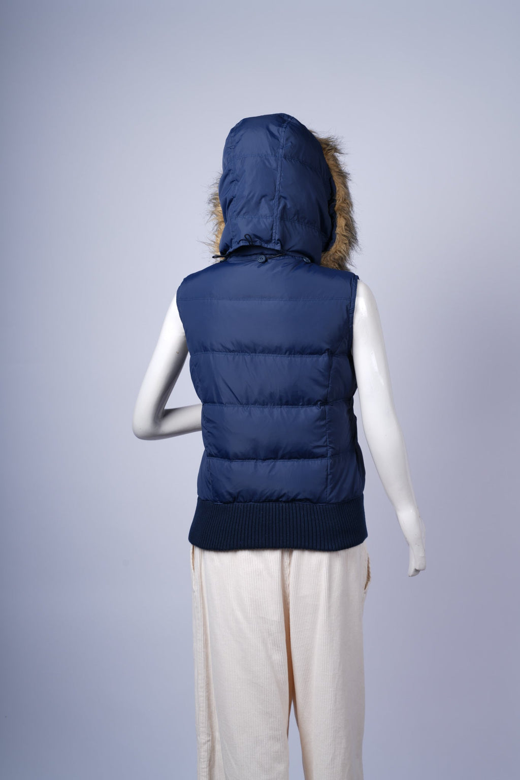 Versatile navy puffer vest perfect for layered winter styling with cozy details.