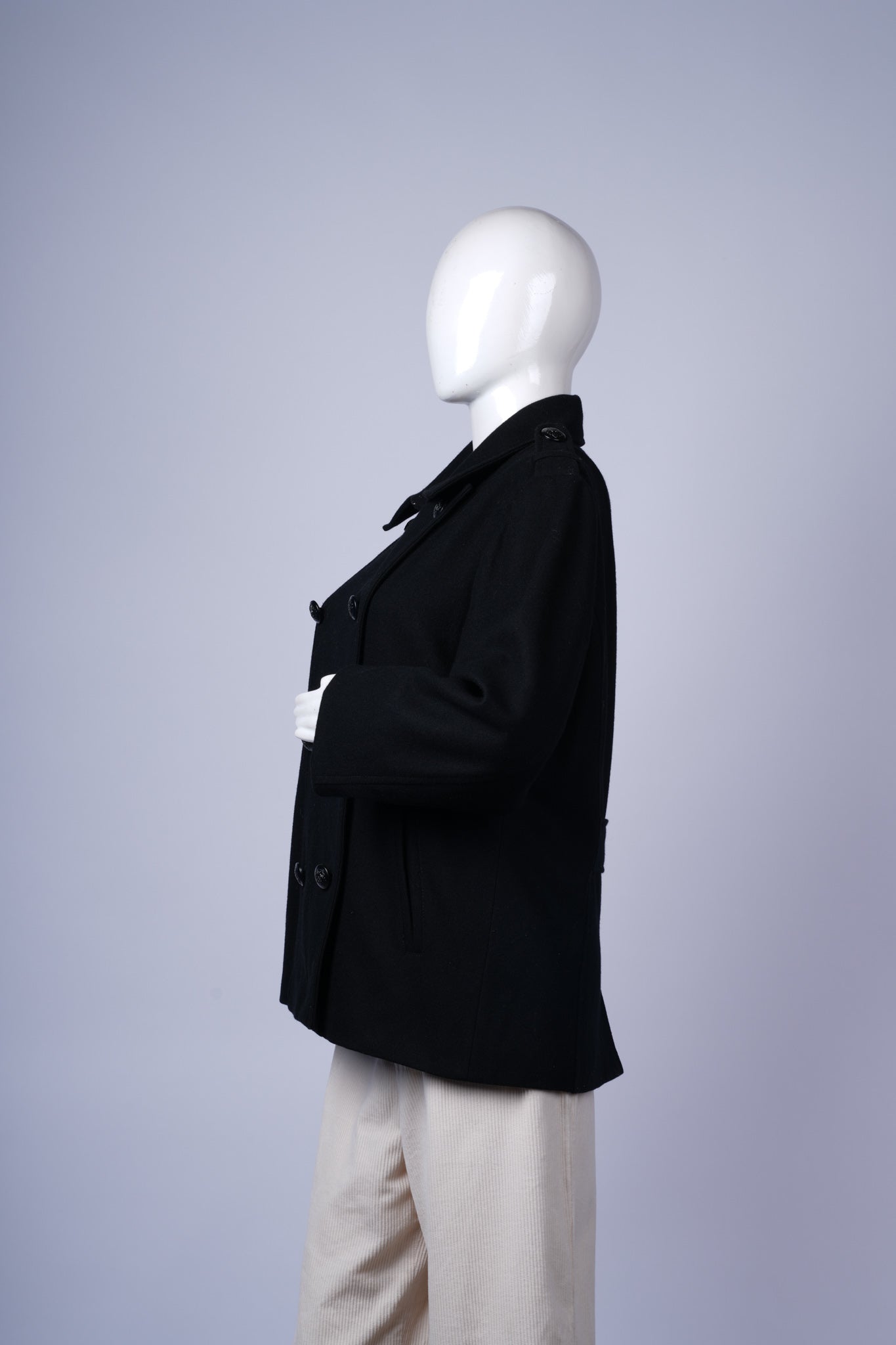 Stylish double-breasted wool coat with structured fit and versatile design.