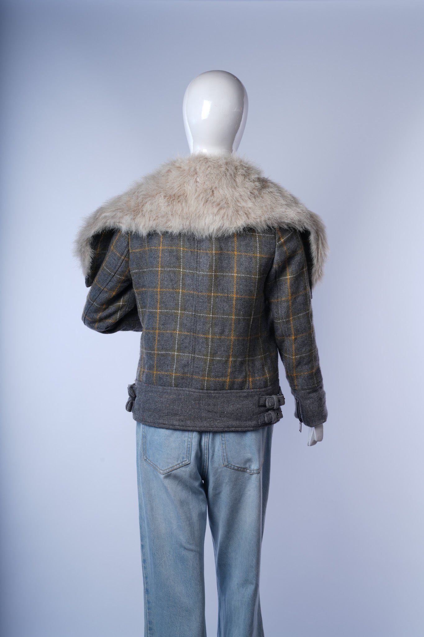 Wool-blend moto jacket combining plaid pattern with faux fur details for modern elegance.