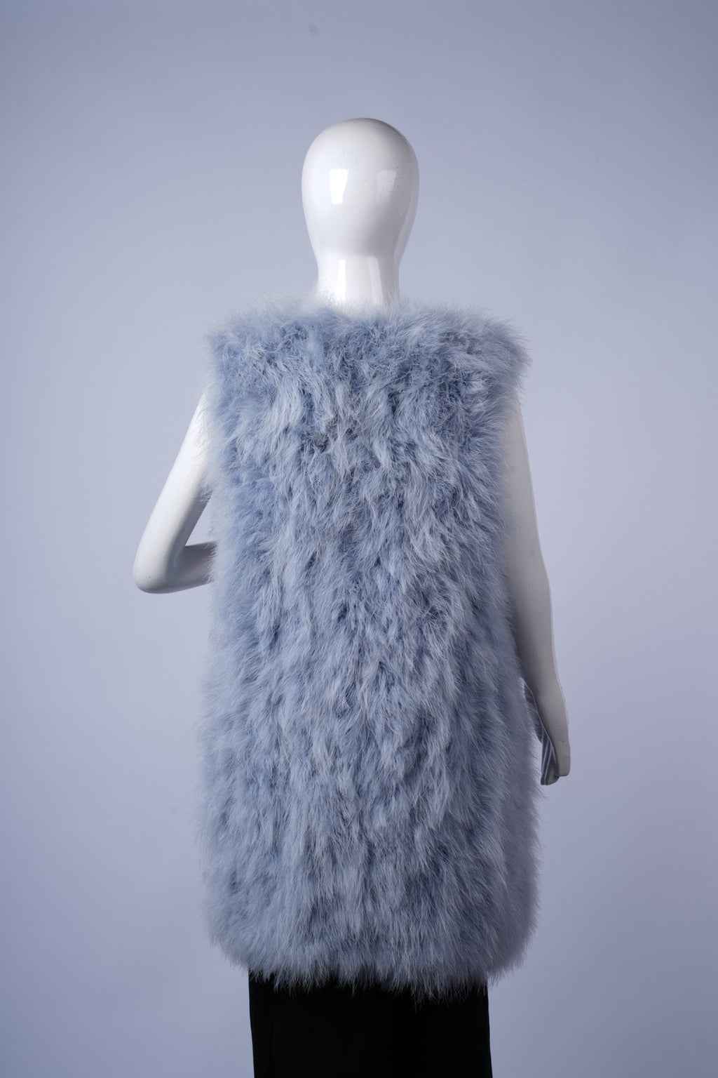 Elegant sleeveless vest with luxurious shaggy fabric for fashionable cold-weather wear.