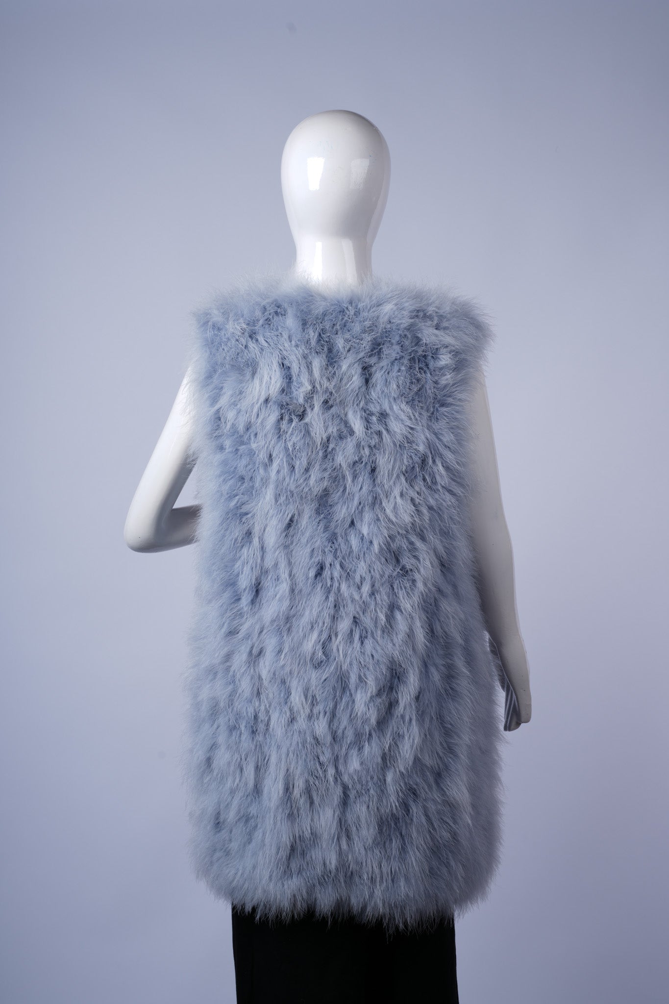 Elegant sleeveless vest with luxurious shaggy fabric for fashionable cold-weather wear.