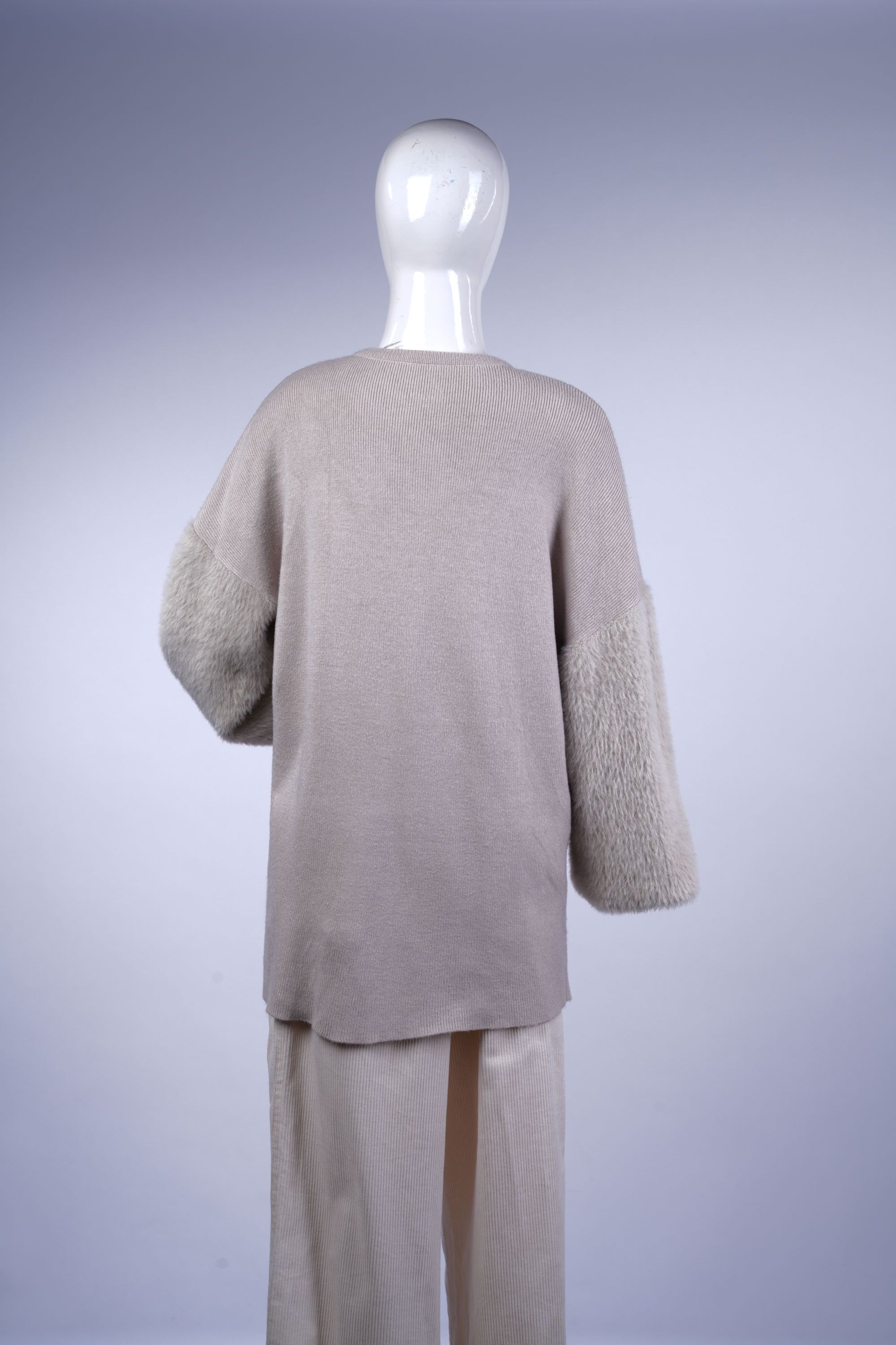Warm beige sweater perfect for casual or chic winter styling.