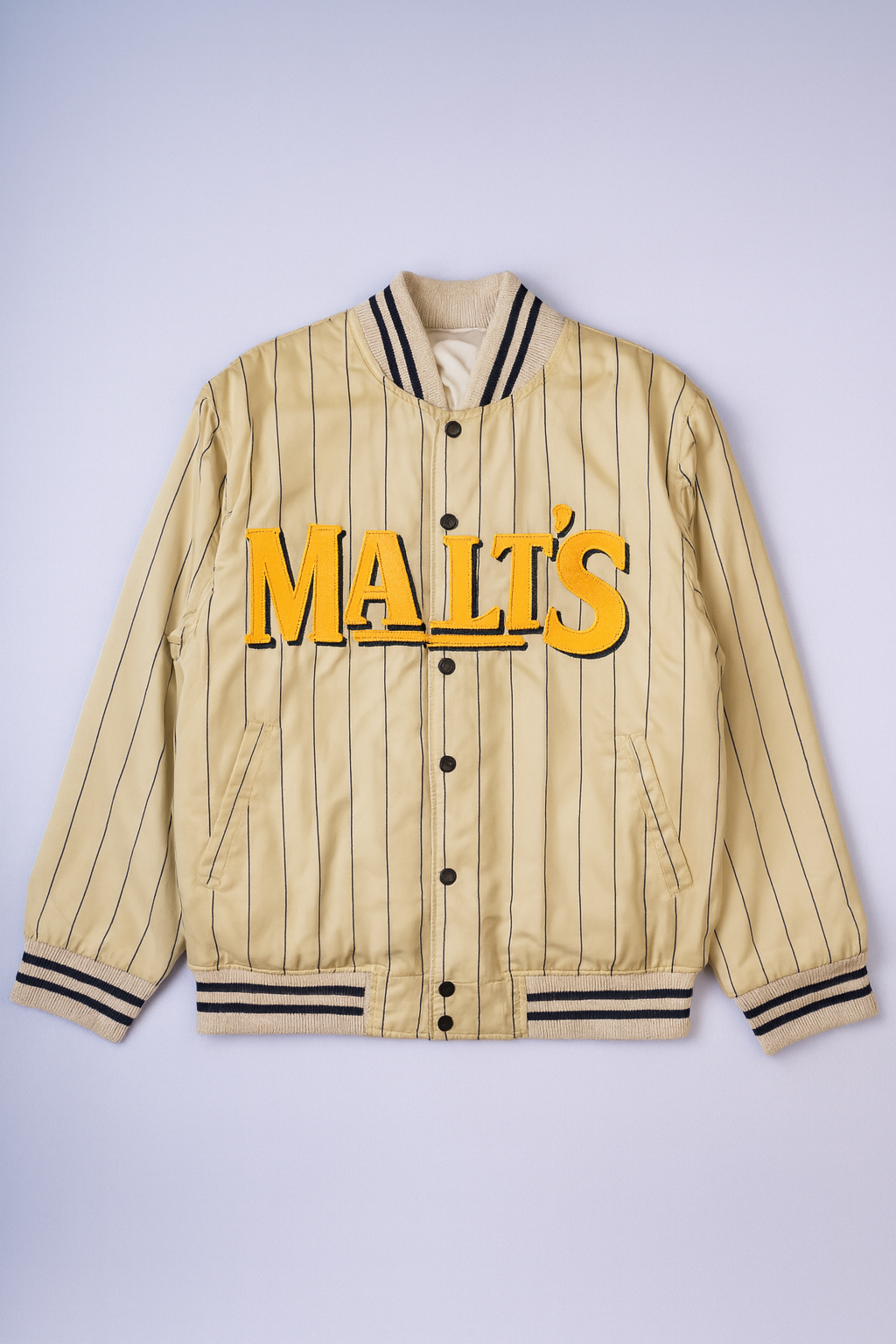 Vintage reversible varsity jacket with ?MALT?S? embroidery in classic cream.