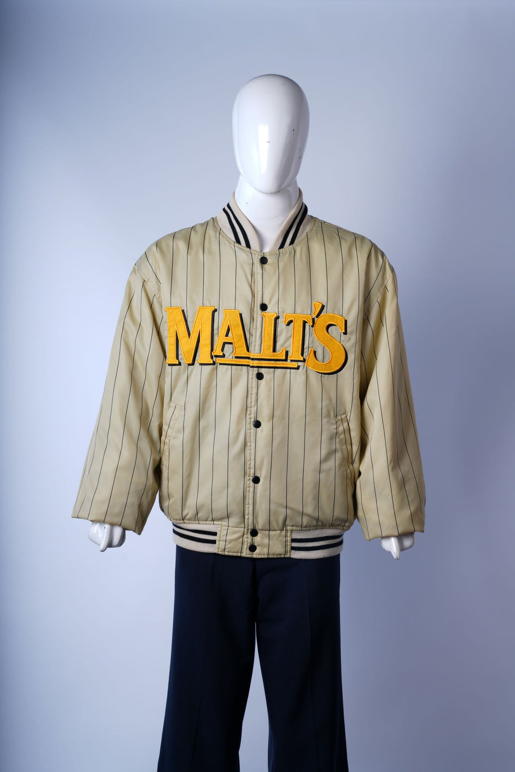 Retro-style cream baseball jacket with satin-like material and embroidered details.