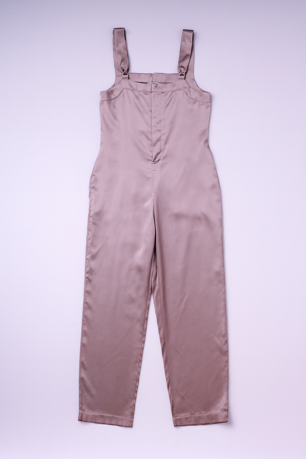 Champagne-pink satin sleeveless jumpsuit with front patch pockets.