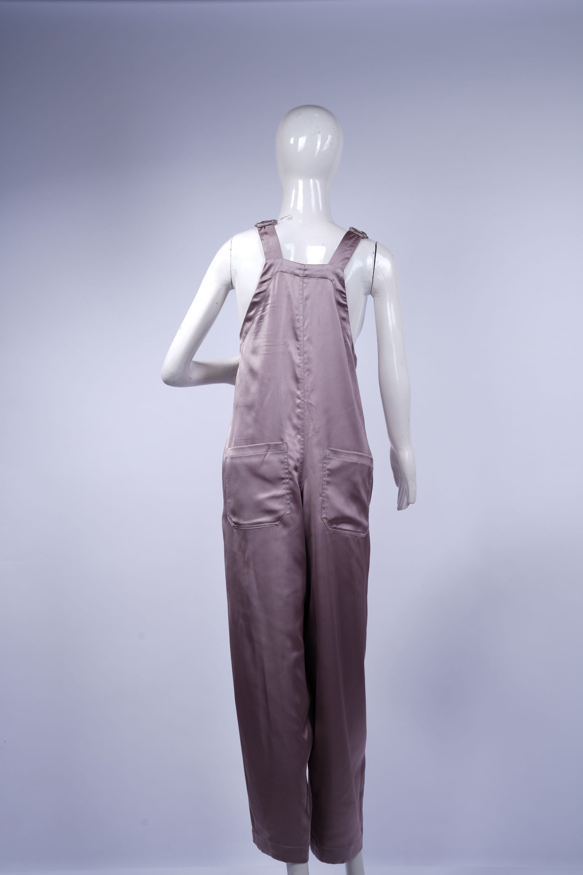 Soft pink satin jumpsuit combining sophistication with comfortable styling.