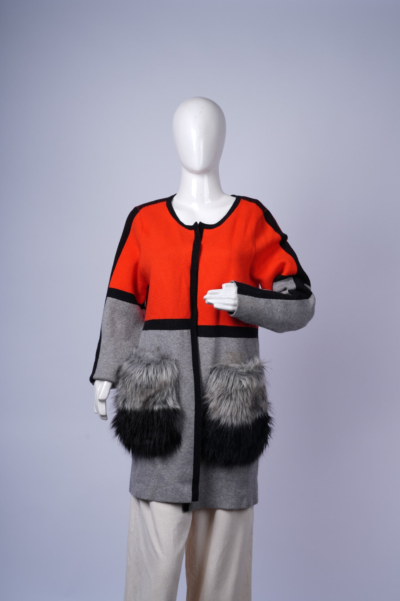 women's cozy striped cardigan featuring faux fur pockets for added warmth.