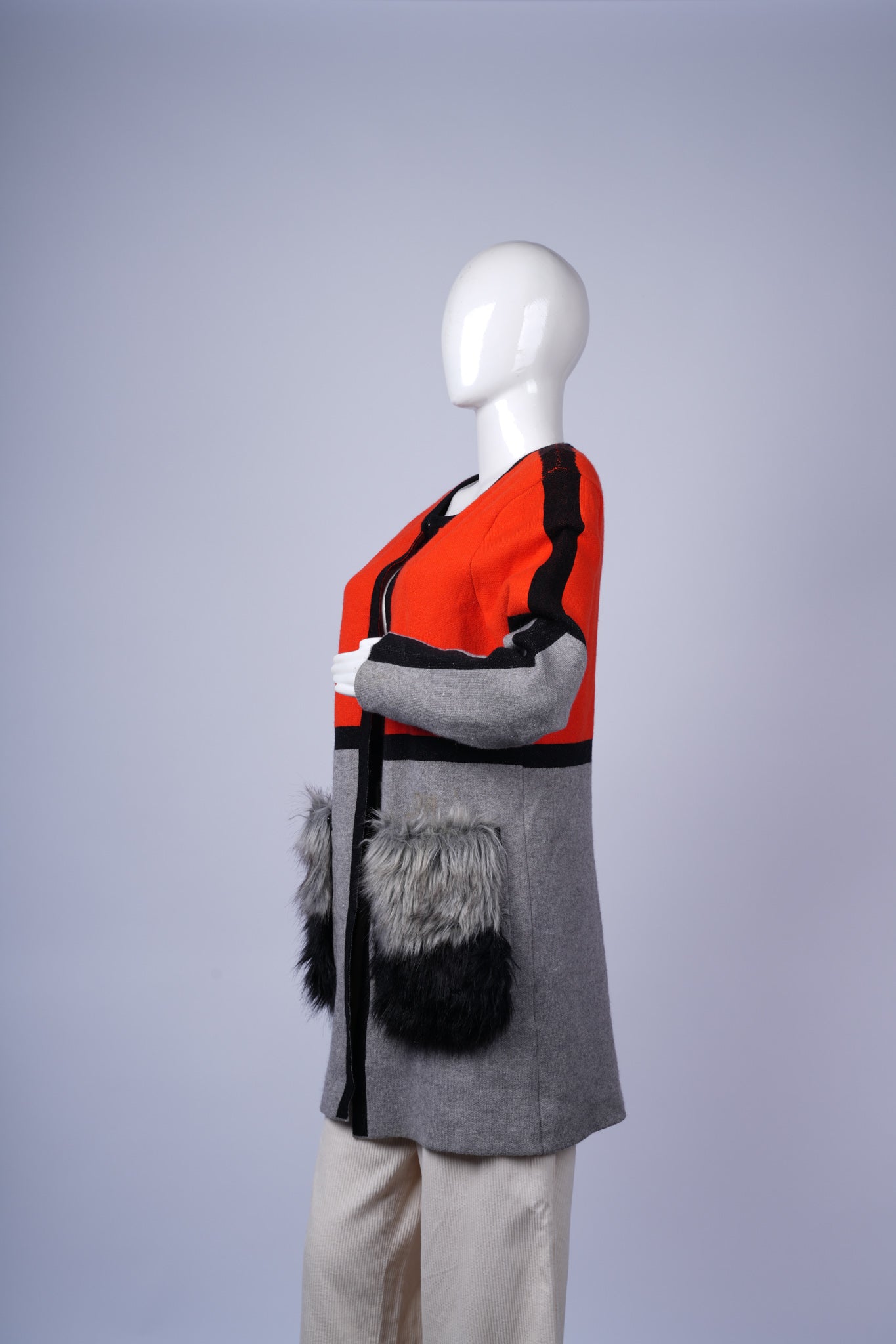 Stylish winter layering piece with bold stripes and soft textured accents.